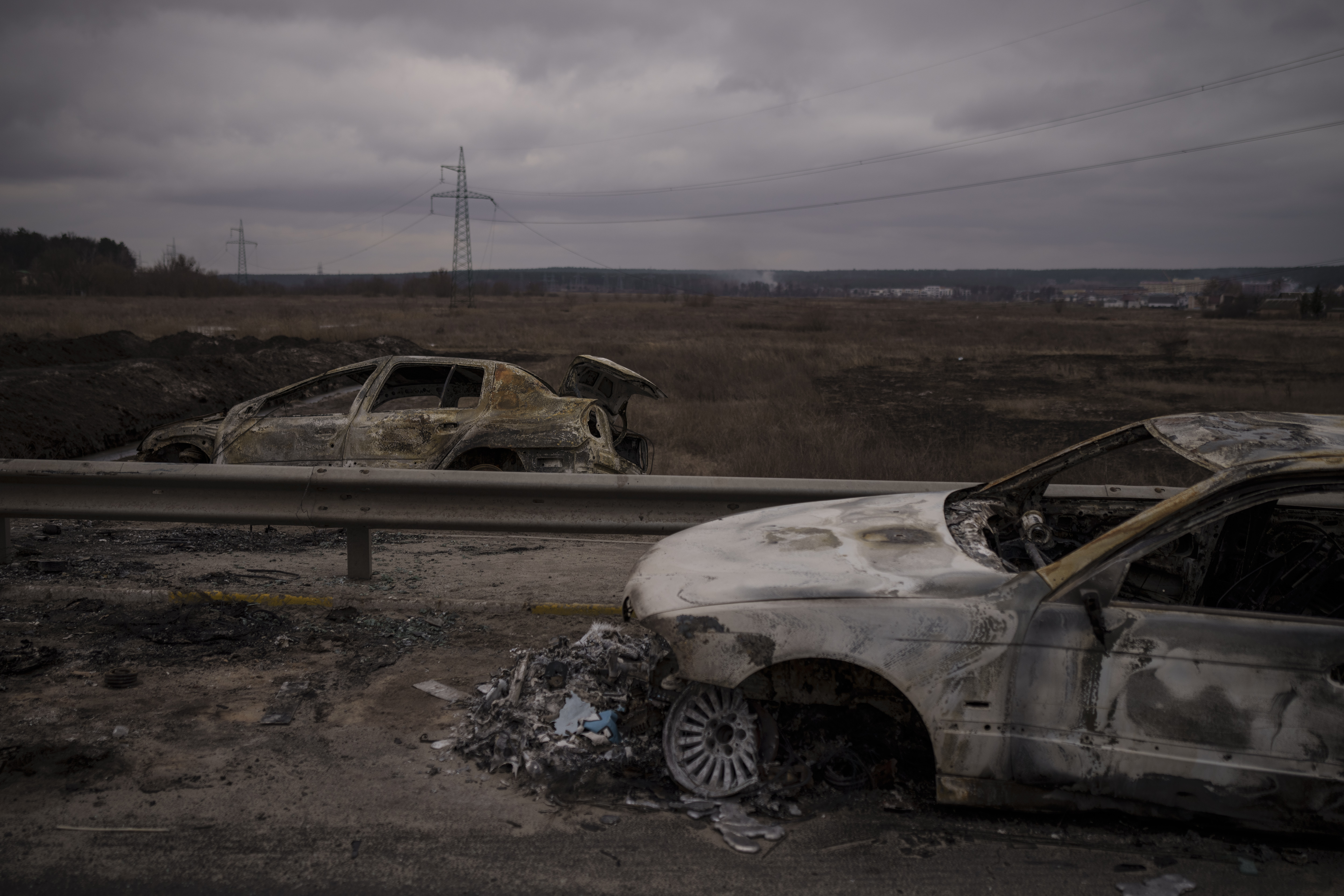 Destroyed cars on a road being used as an evacuation route out of Irpin, on the outskirts of Kyiv