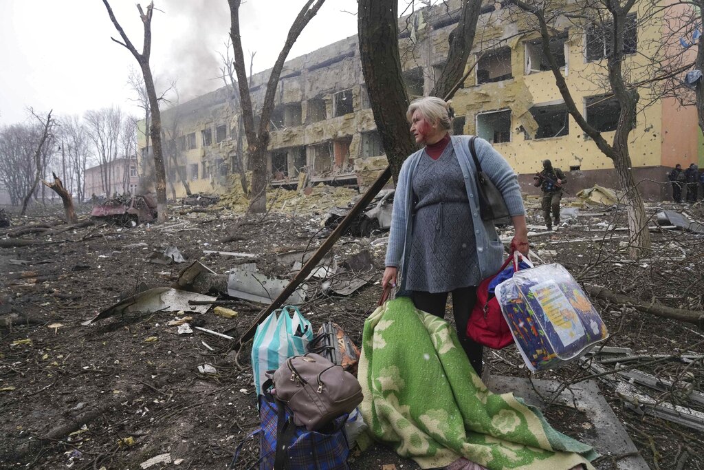 A woman walks outside a maternity hospital that was damaged by shelling in Mariupol, Ukraine.