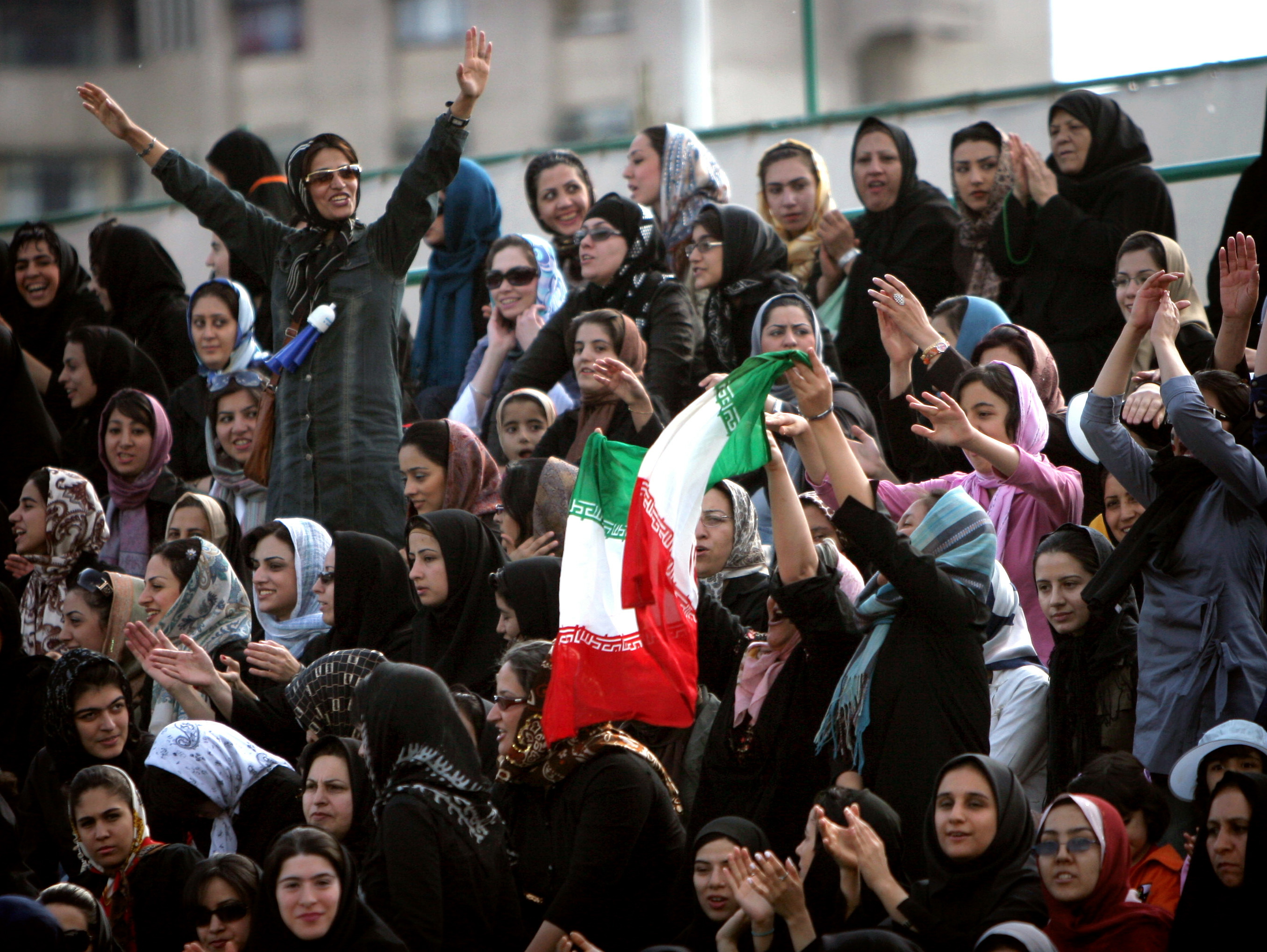 Iranian fans shout slogans in support of Iran's national women's soccer team