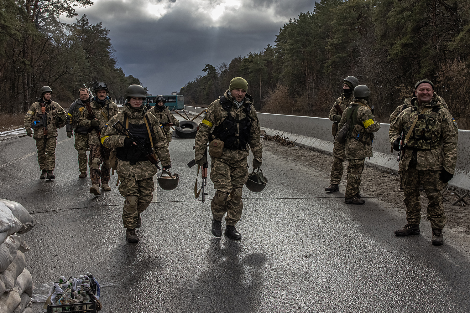 Members of the Ukrainian military walk at a checkpoint near Brovary, in the eastern frontline of Kyiv region.