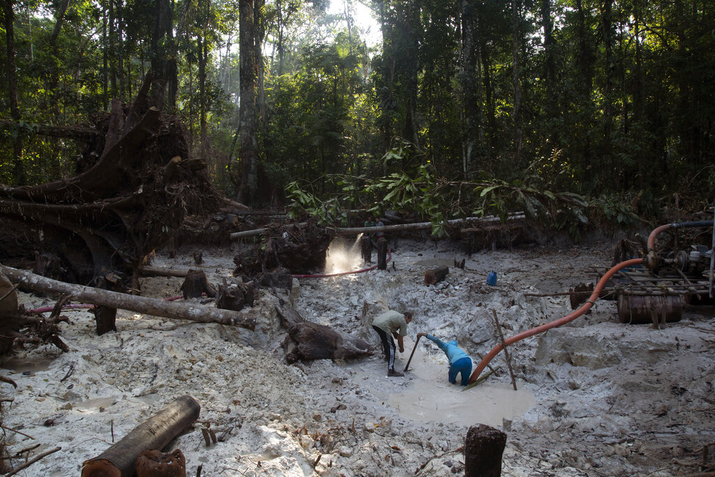 Men search for gold at an illegal gold mine in the Amazon jungle in the Itaituba area of Para state, Brazil.
