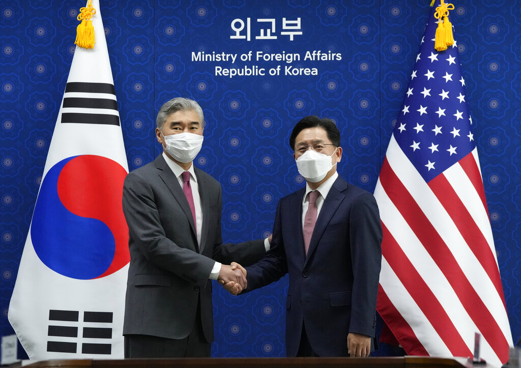 U.S. Special Representative for North Korea, Sung Kim, left, shakes hands with South Korea's Special Representative for the Korean Peninsula Peace and Security Affairs Noh Kyu-duk as they pose for a photo during a meeting at the Foreign Ministry in Seoul.