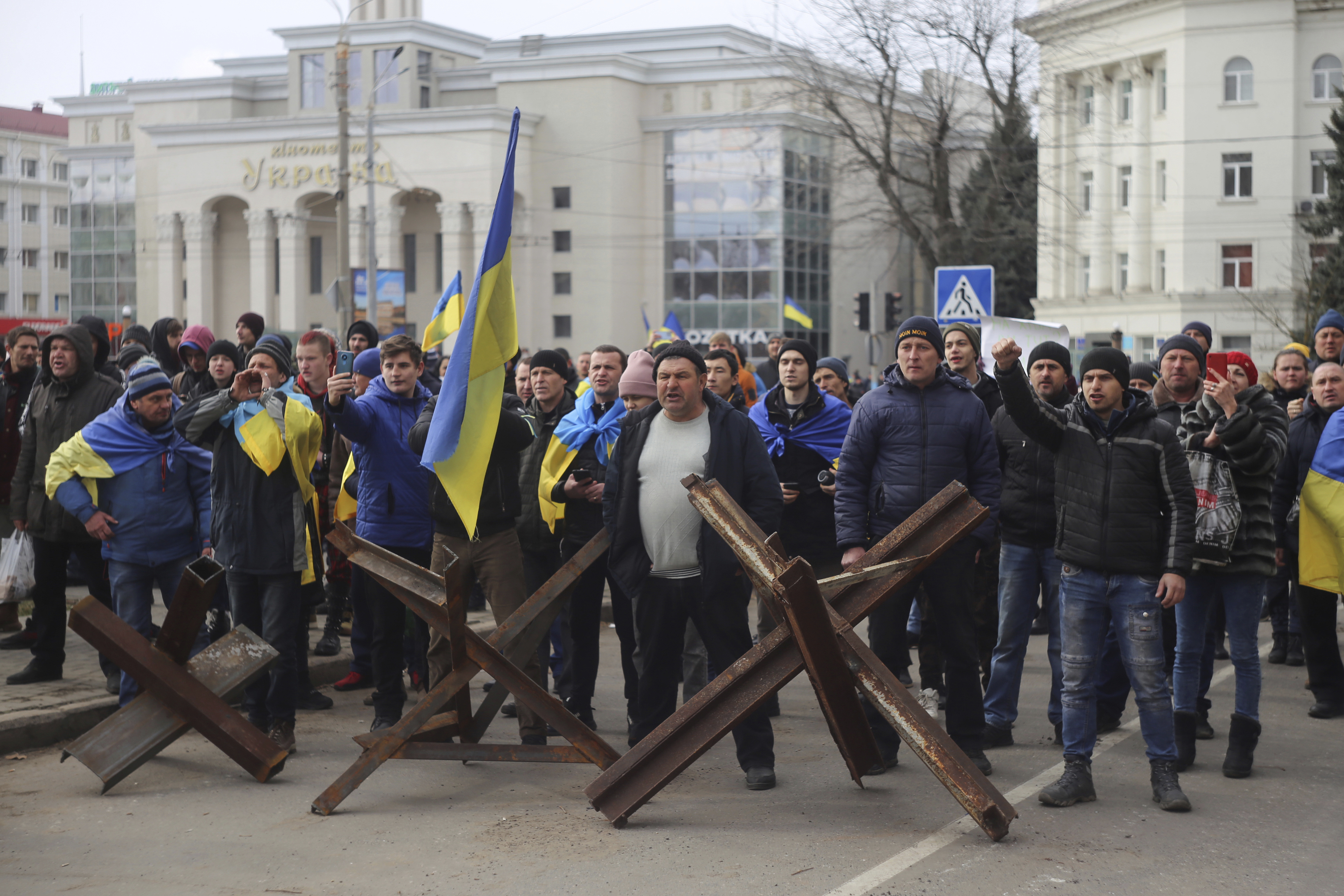 People shout toward Russian army soldiers during a rally against the Russian occupation in Svobody (Freedom) Square in Kherson, Ukraine, Monday, March 7, 2022. Ever since Russian forces took the southern Ukrainian city of Kherson in early March.