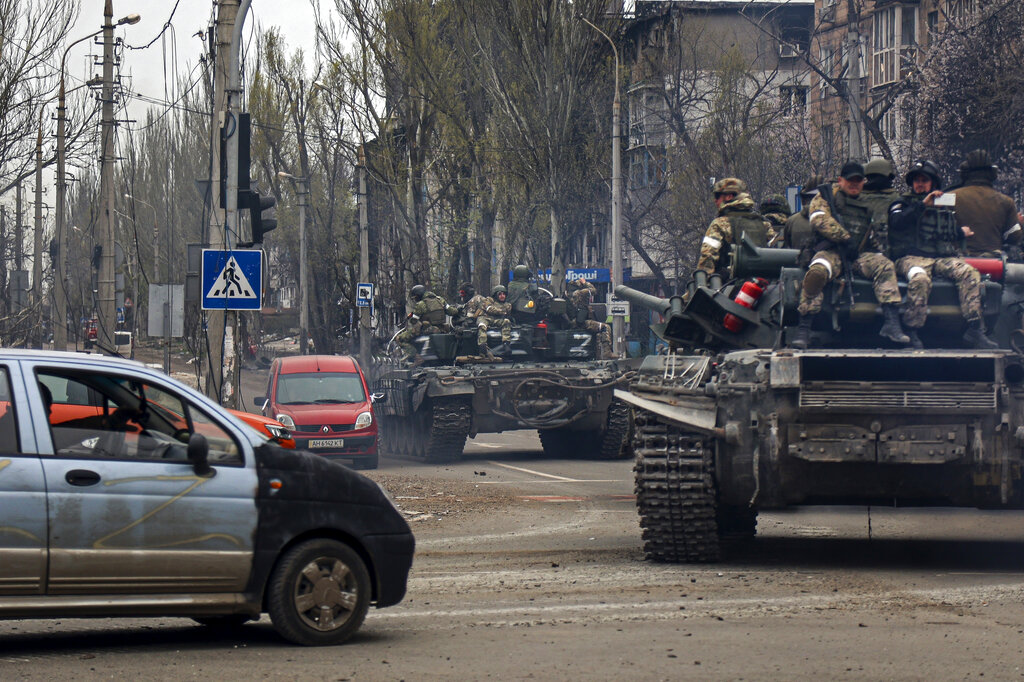 Russian tanks roll along a street in an area controlled by Russian-backed separatist forces in Mariupol, Ukraine.