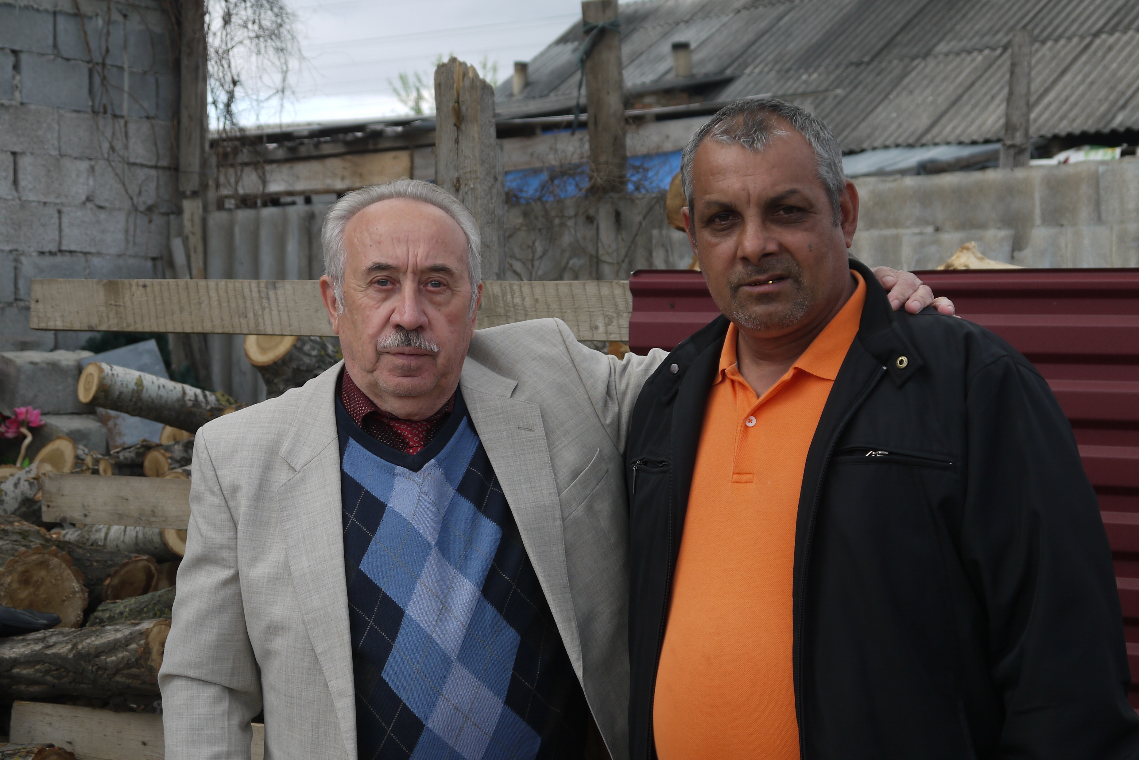 653.jpg. Ivan Balog (right), a Roma pastor, stands with a non-Roma refugee who is sheltering at the church in his Roma community.