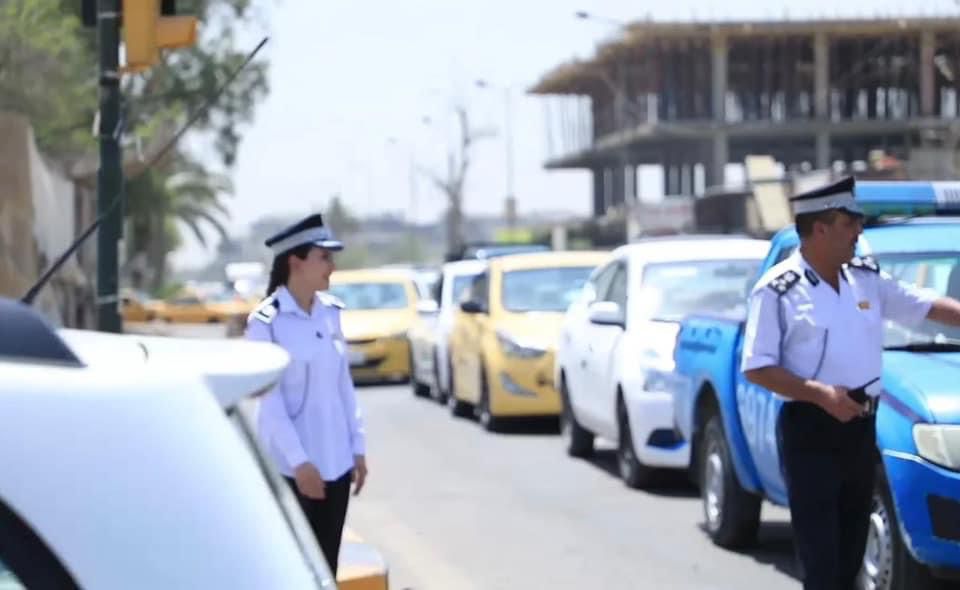 Police men and women in streets of Baghdad.