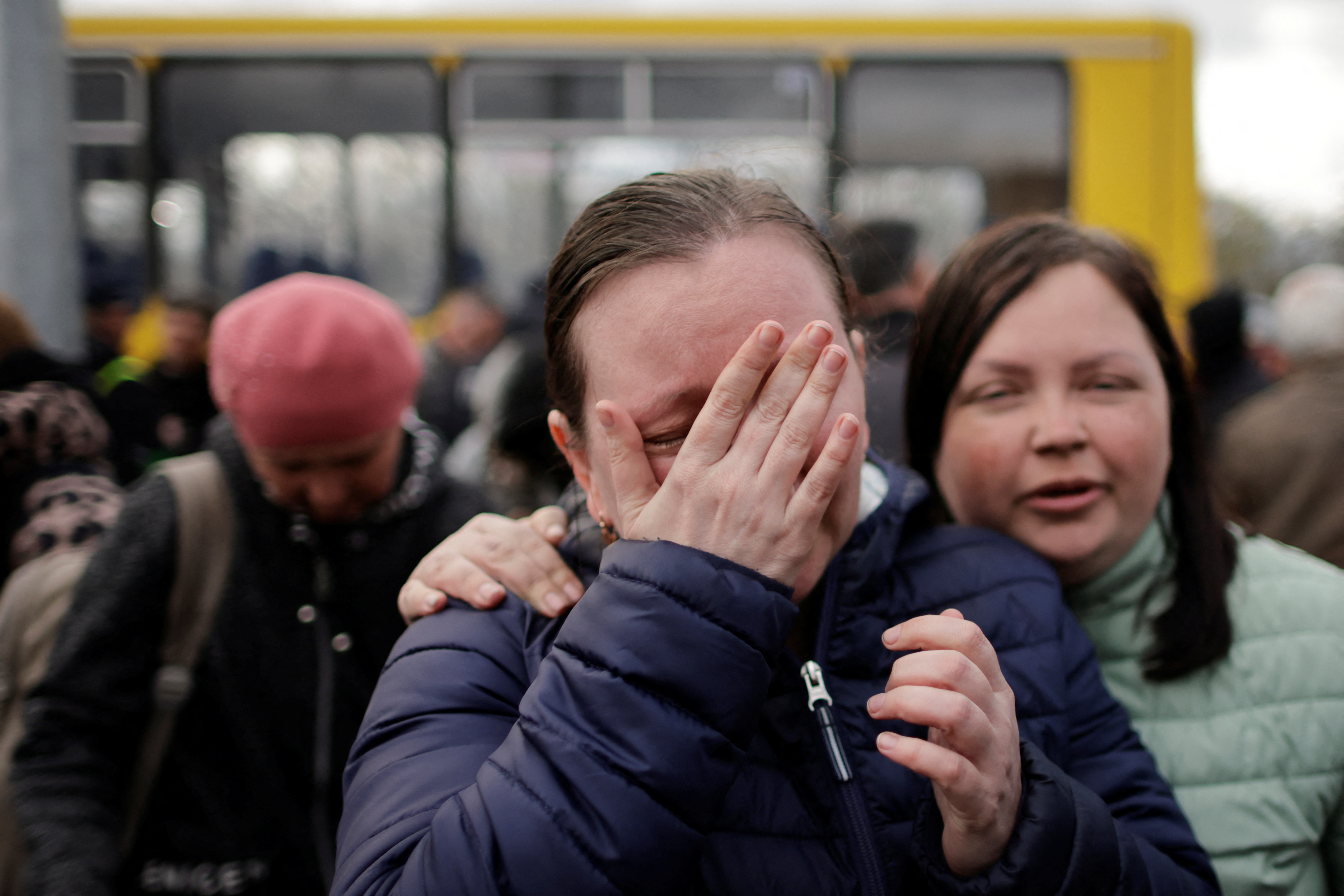 A Ukrainian woman from Mariupol cries after safely arriving in Zaporizhzhia in a small convoy that crossed through territory held by Russian forces, on April 21, 2022