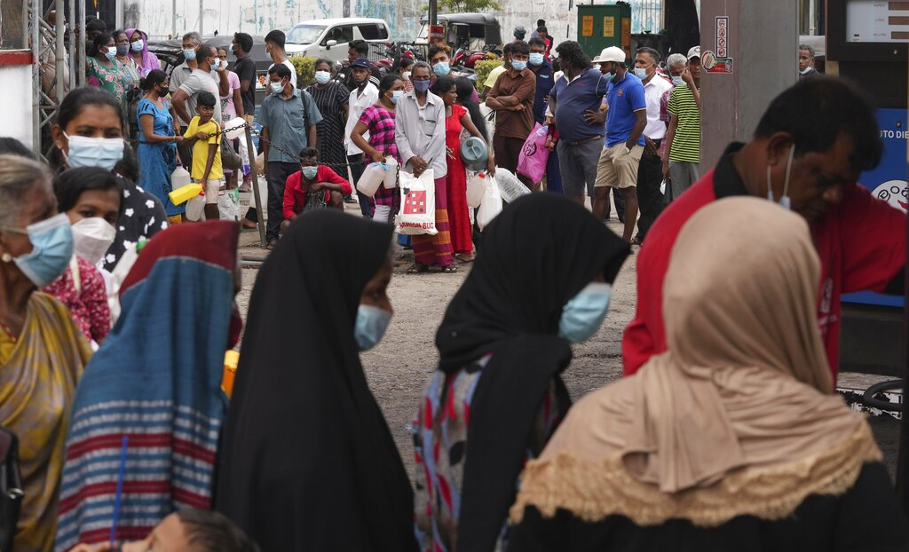 Sri Lankans queue up near a fuel station to buy kerosene in Colombo, Sri Lanka
