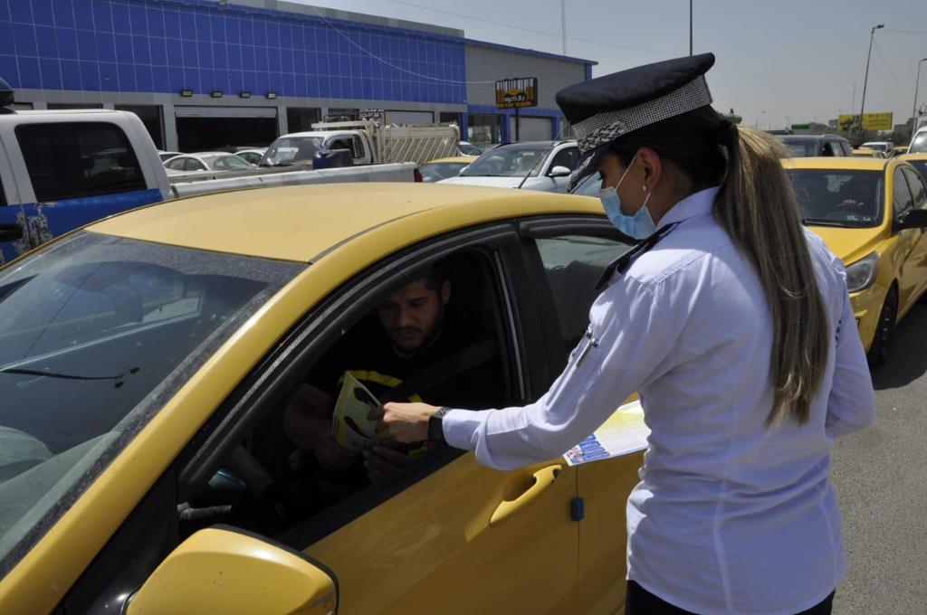 Policewoman standing in street.