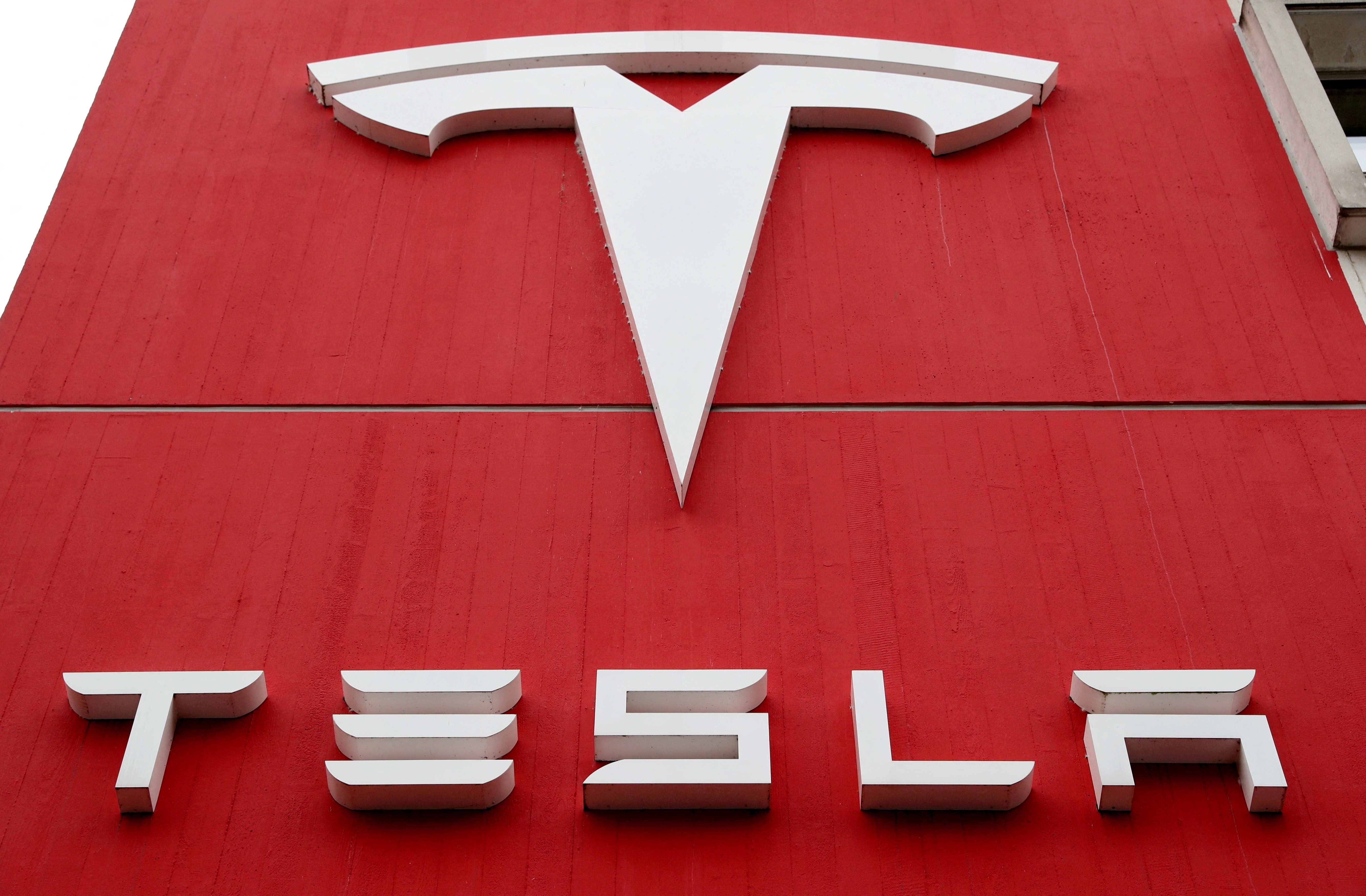 The logo of car manufacturer Tesla is seen at a branch office in Bern, Switzerland