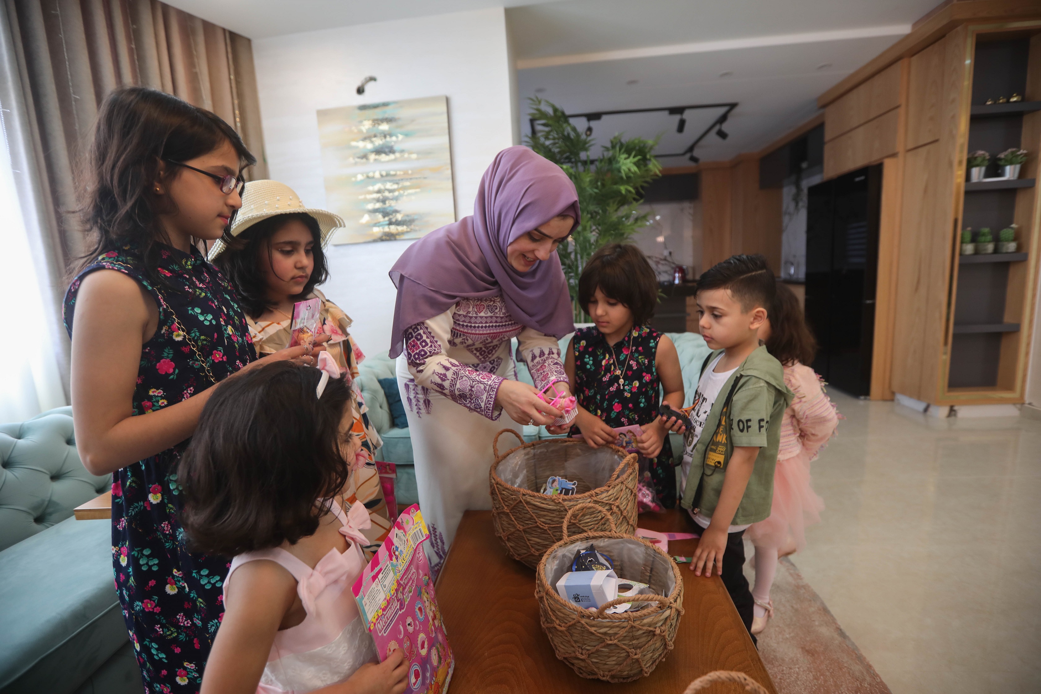 Amani distributes toys, sweets and gifts to the family children