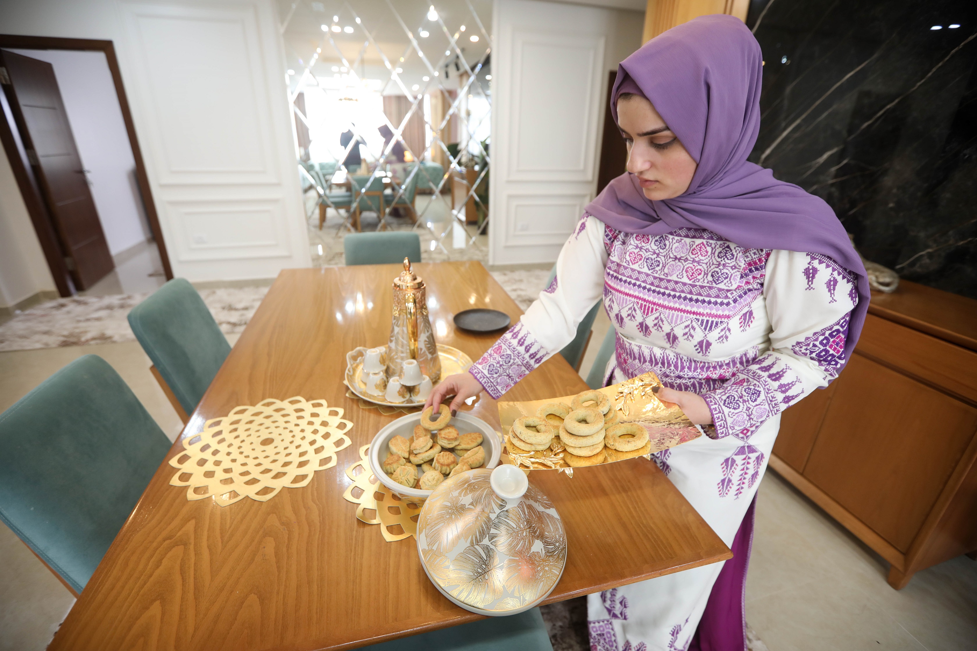 Al-Kahlout wears her embroidered Palestinian dress for Eid