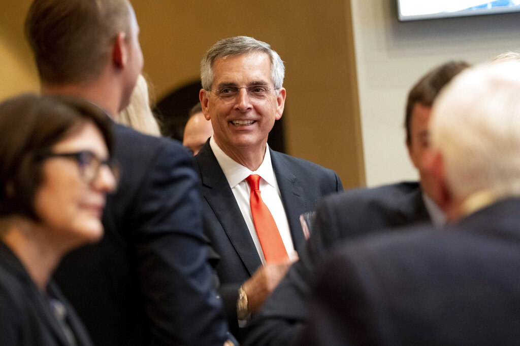 Incumbent Georgia Secretary of State Brad Raffensperger talks with supporters during an election night party.