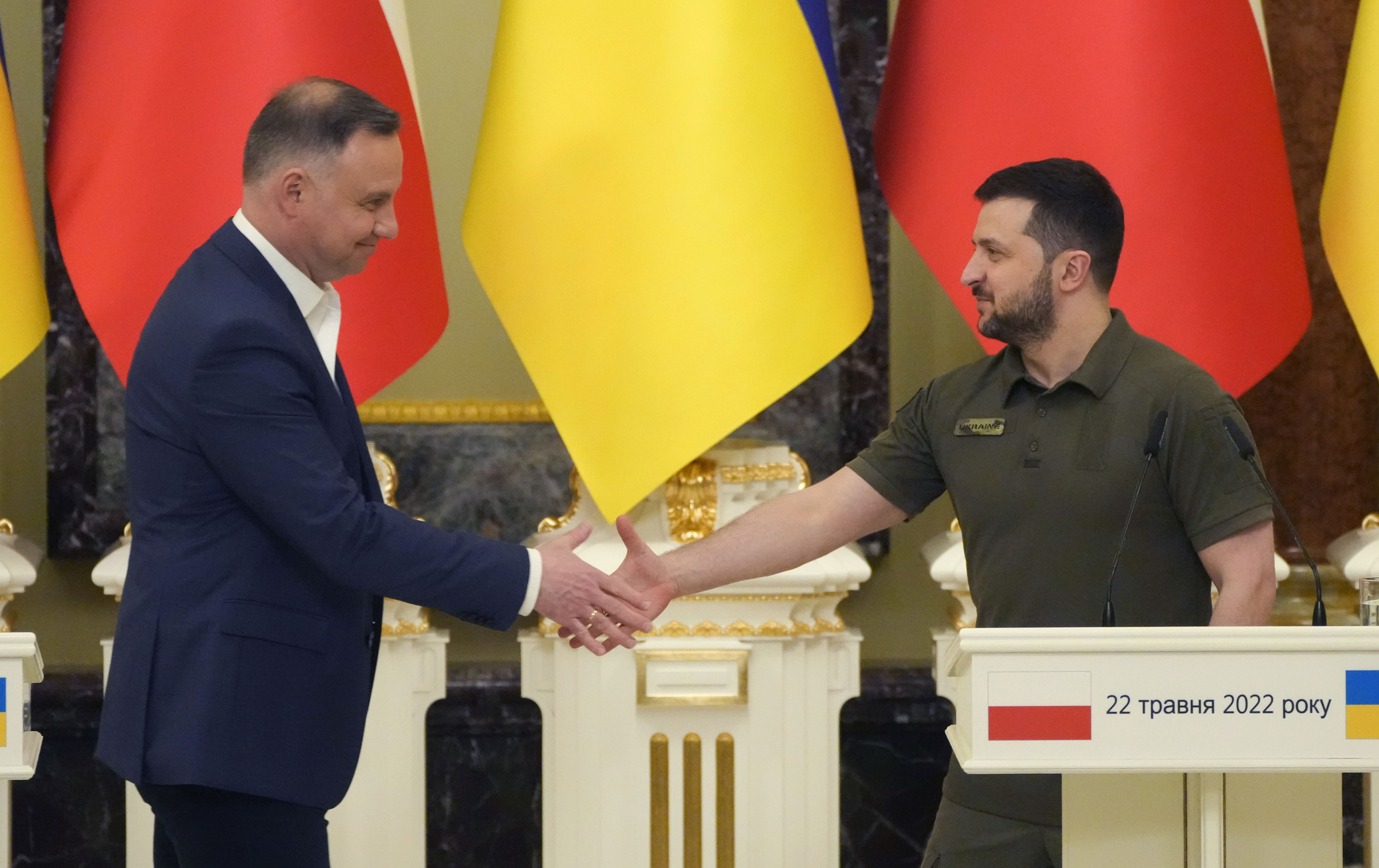 Ukrainian President Volodymyr Zelenskyy, right, and Polish President Andrzej Duda, shake hands during a news conference after their meeting in Kyiv, Ukraine, Sunday, May 22, 2022