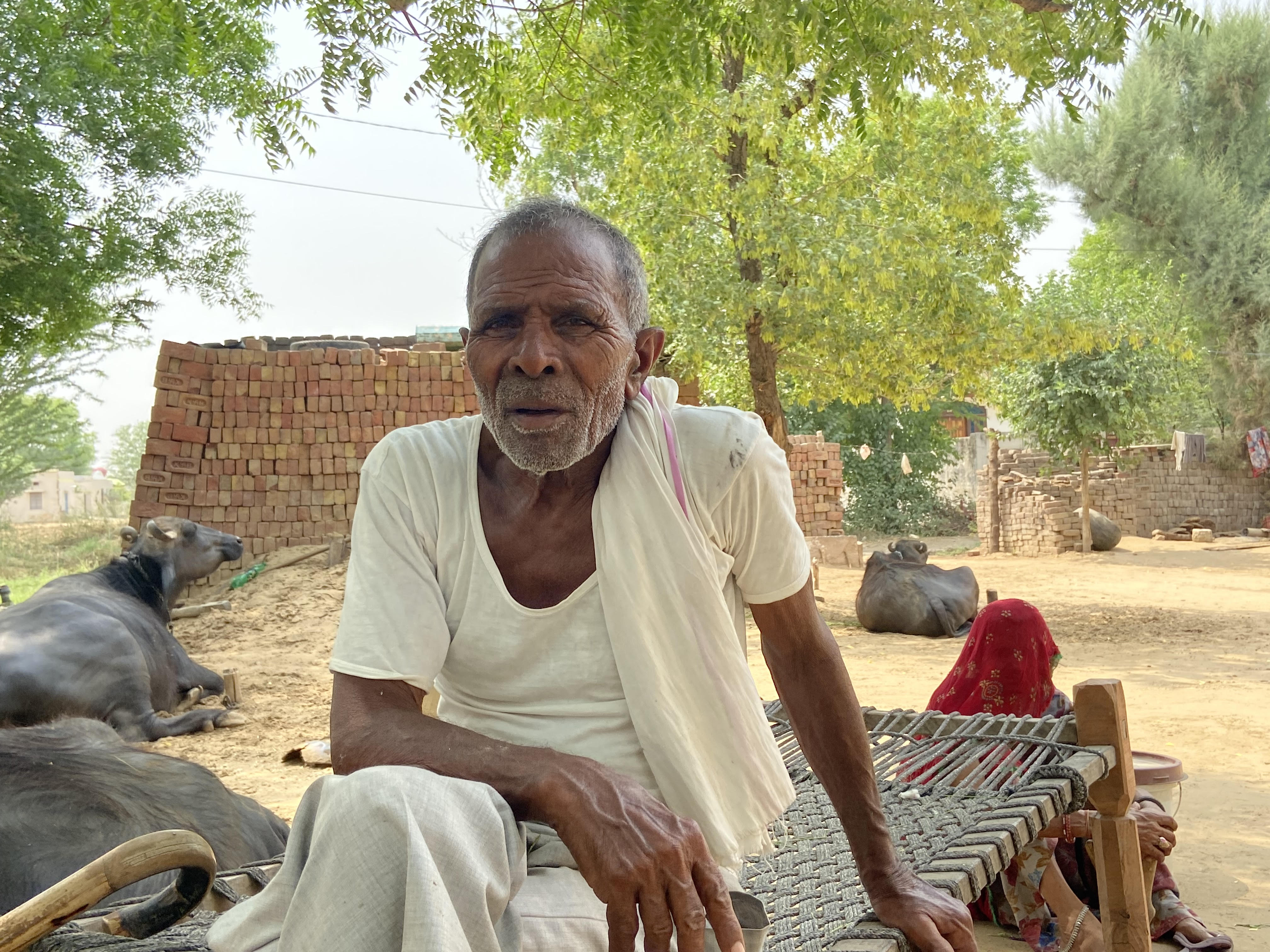 Farmer Matadin Meena on a charpoy in his house in Rajasthan, India