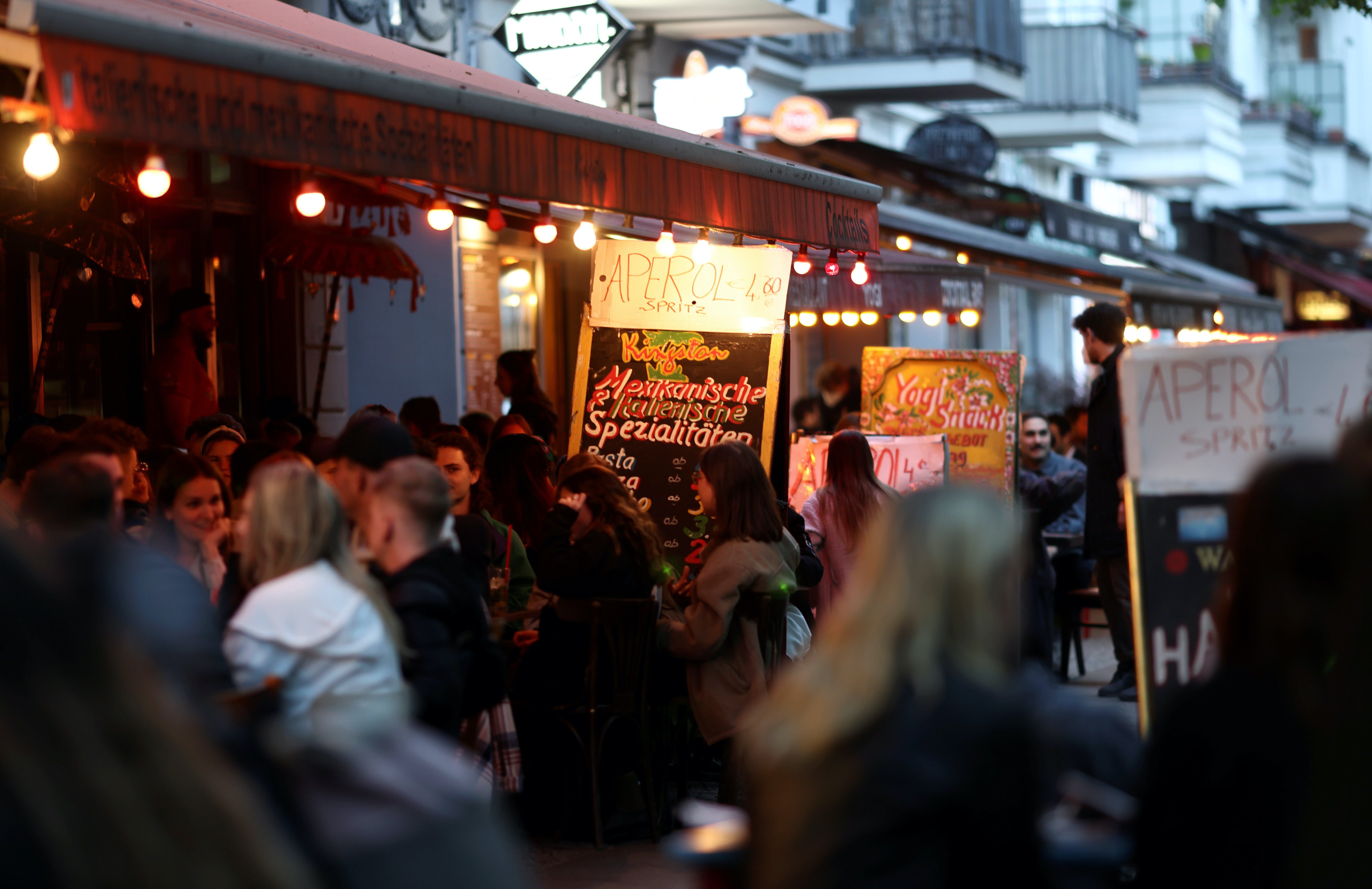 People enjoy the evening at a terrace of a bar