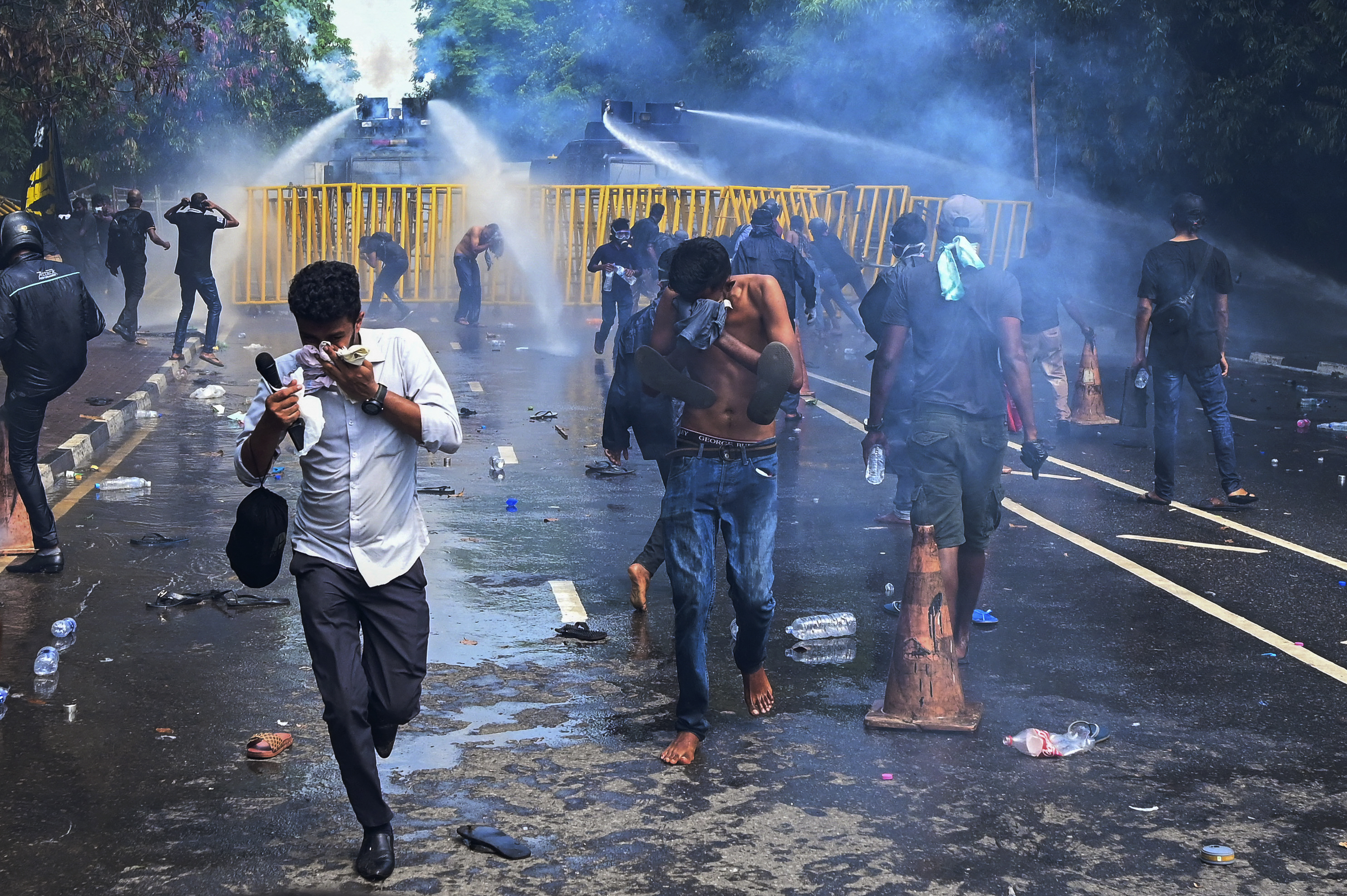 Police use a water canon and tear gas to disperse university students protesting