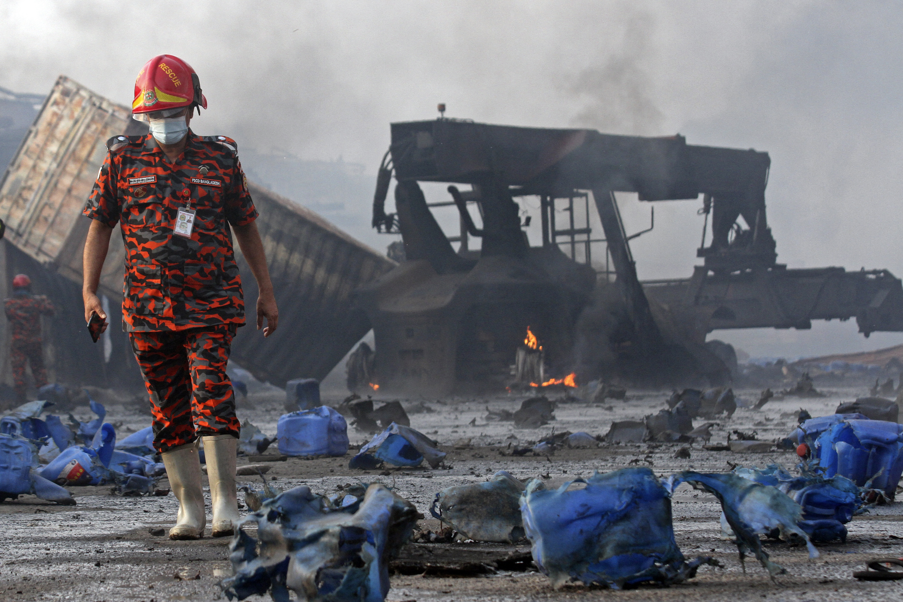 A firefighter stands amid the debris