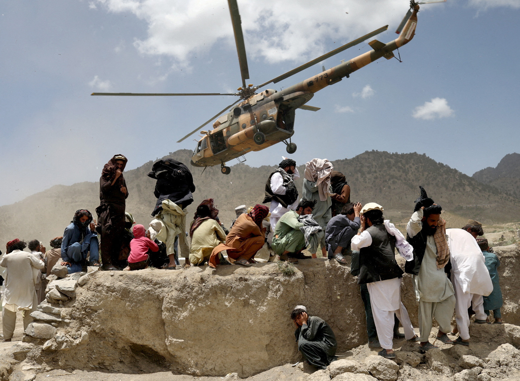 A Taliban helicopter takes off after bringing aid to the site of an earthquake in Gayan