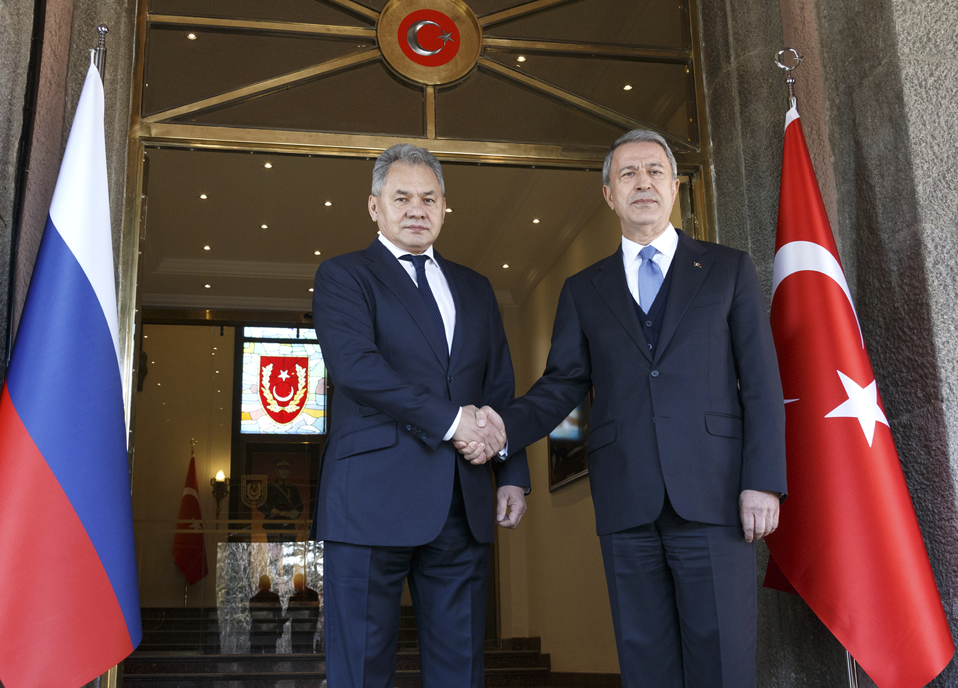 Turkish Defence Minister Hulusi Akar, right, and Russia's Defense Minister Sergei Shoigu pose for a photo during their meeting in Ankara, Turkey, Monday, Feb. 11, 2019.