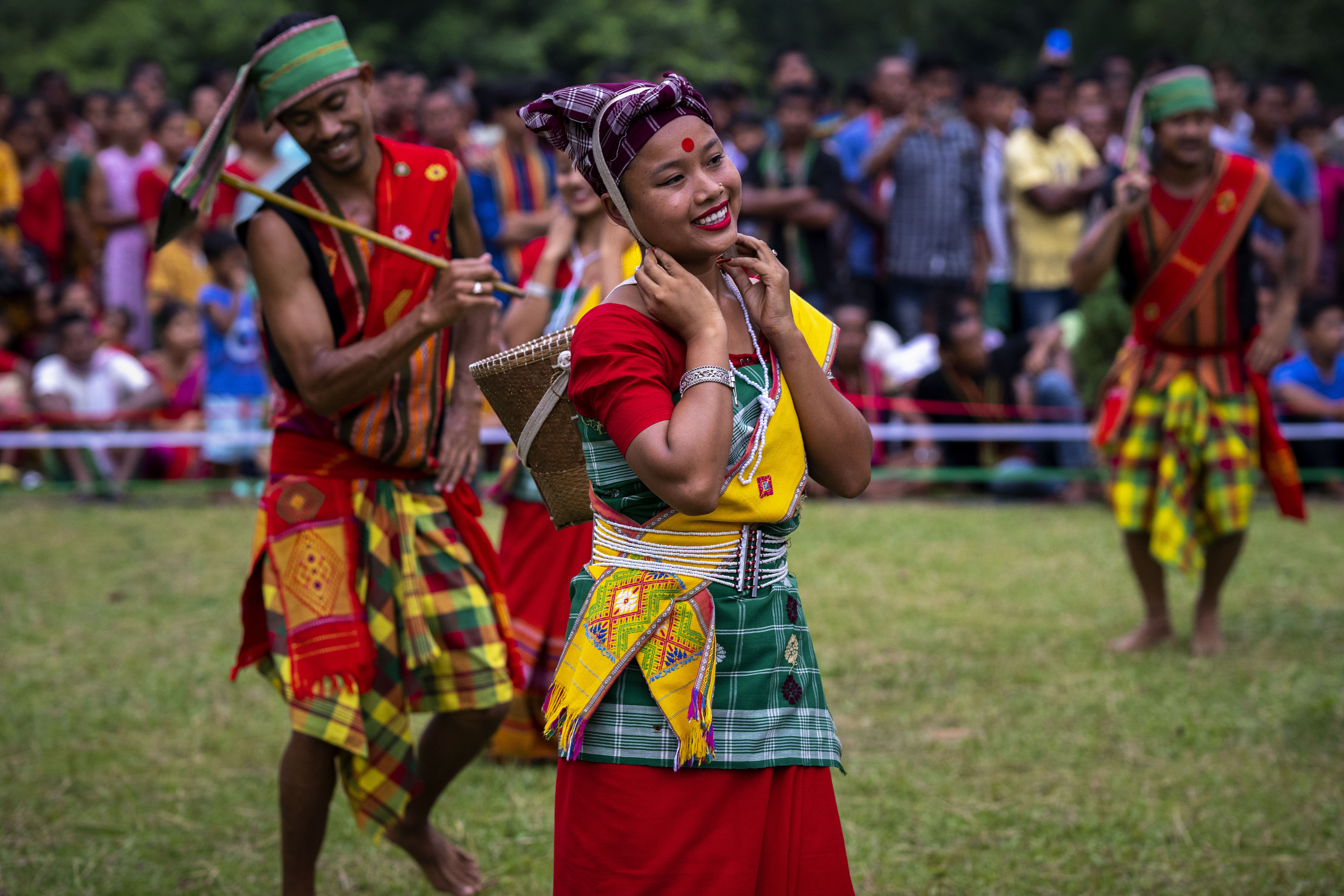 Indian Rabha tribal girls in traditional attire dance during Baikho festival at Gamerimura village