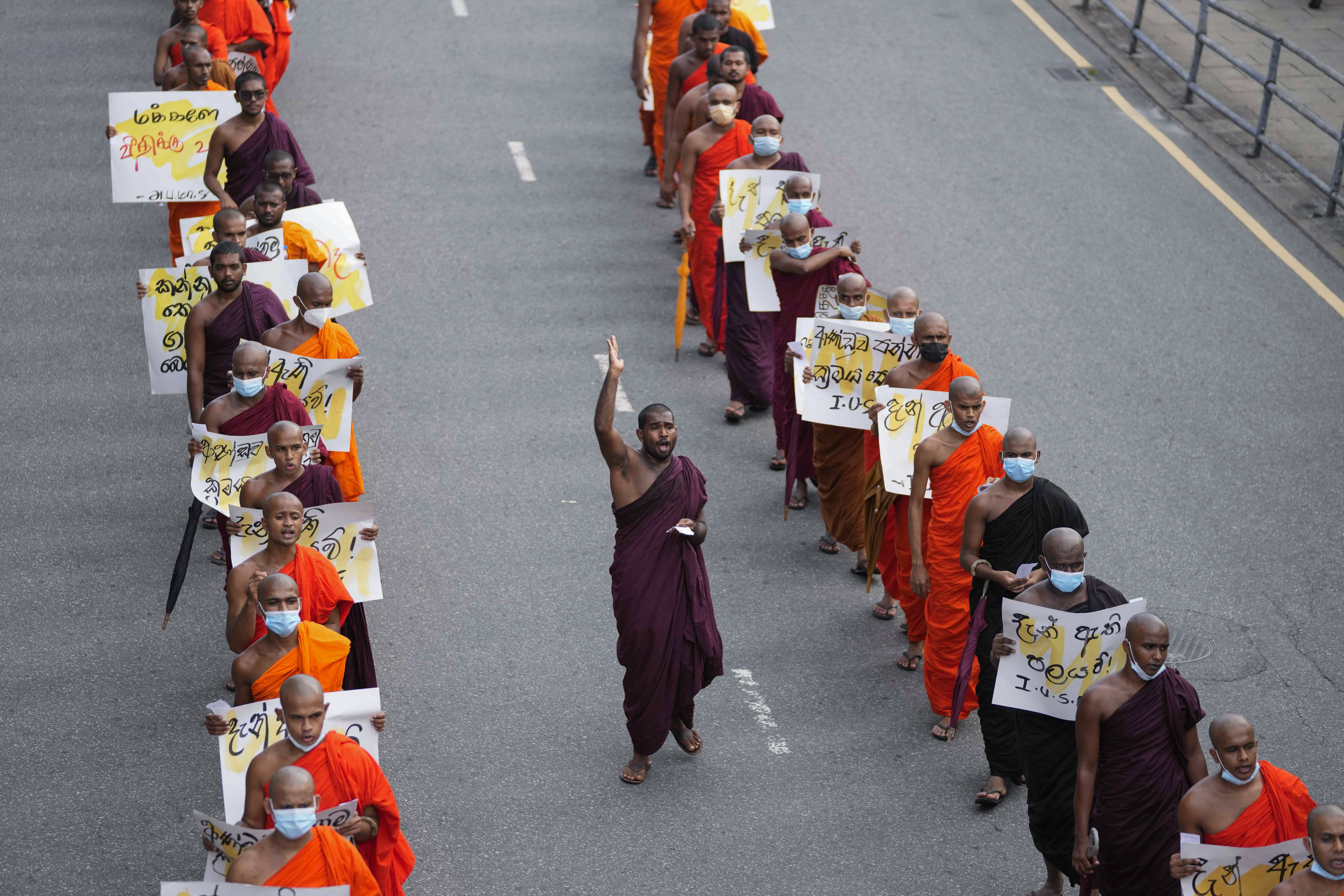 Sri Lankan student Buddhist monks shout slogans as they march demanding President Gotabaya Rajapaksa resign