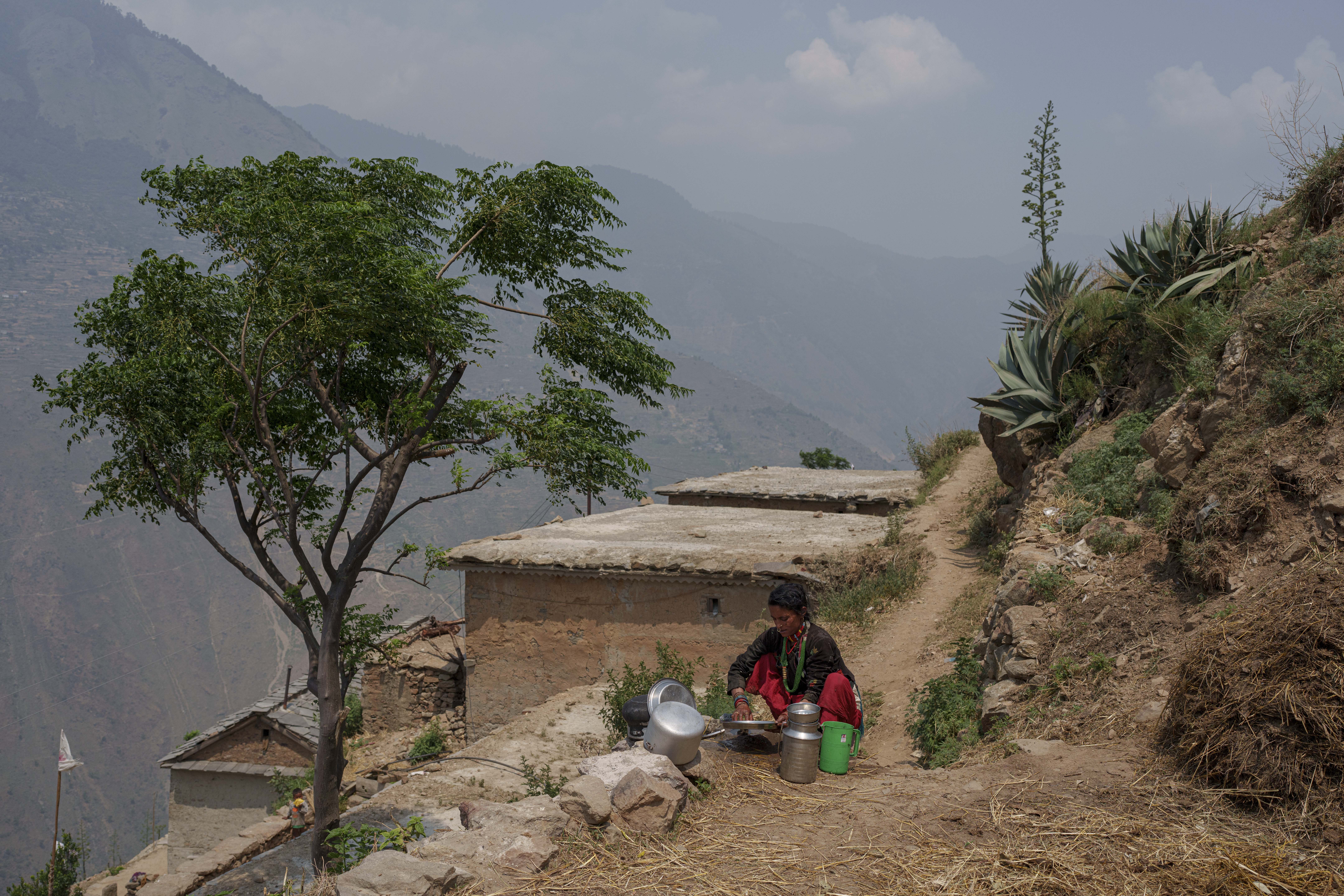 Lachchu Bishwokarma, 41, a Malnourished woman washes dishes at in Muktikot