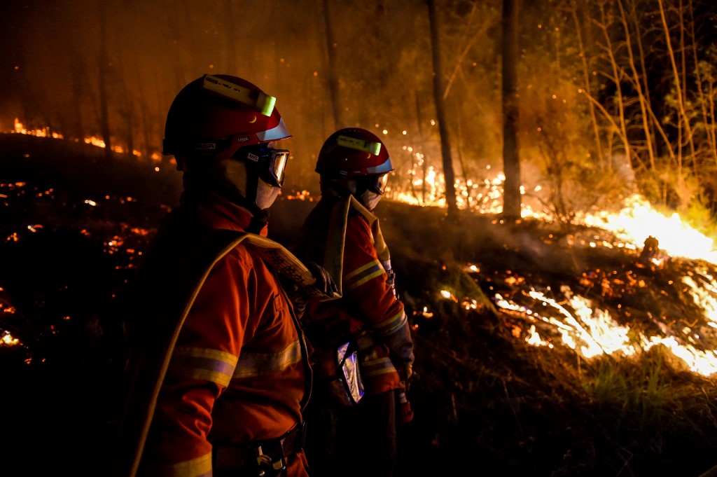 Firefighters stand by a wildfire near Besseges, southern France