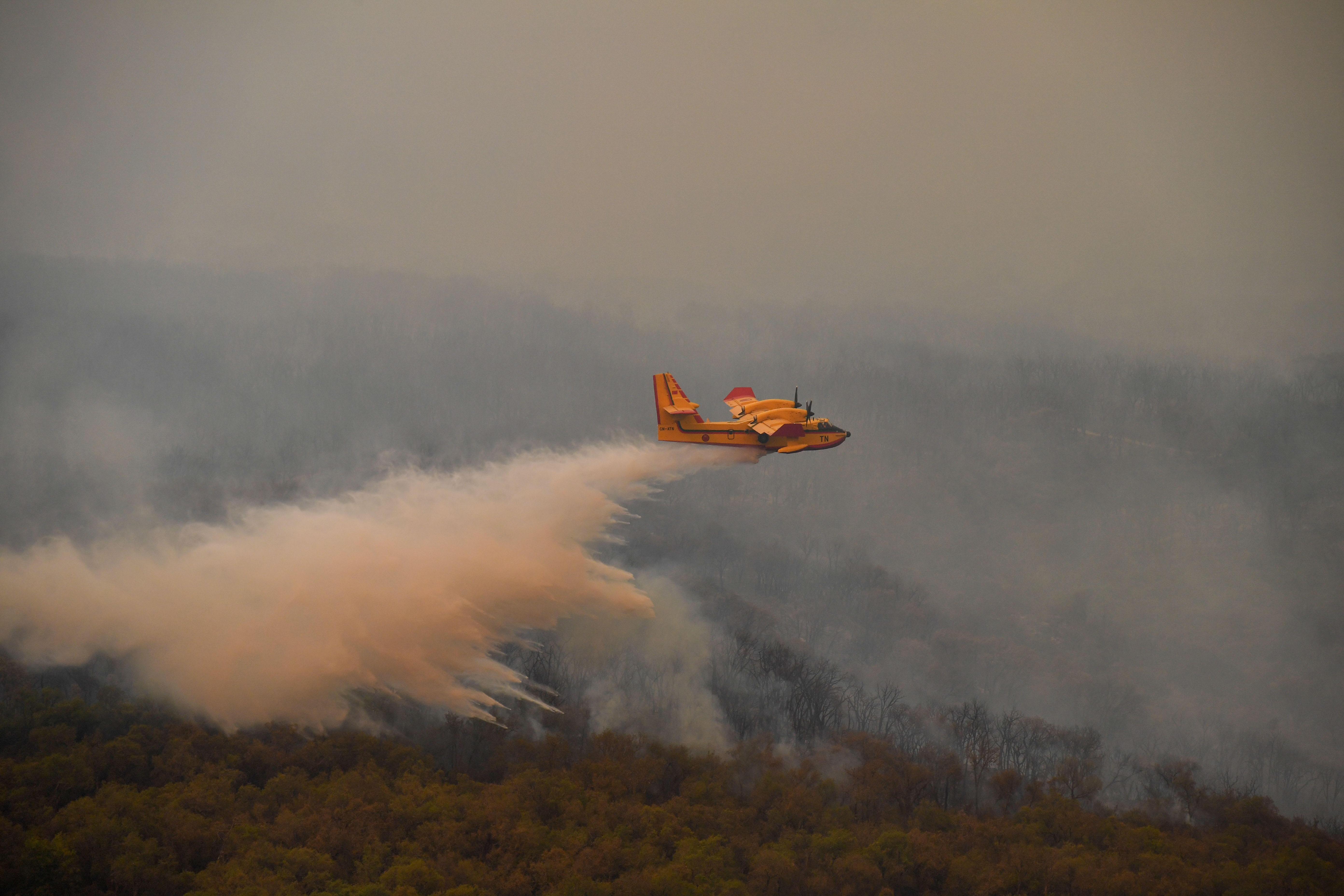 Firefighter plane releases water to put the fire out which broke out in Rabat