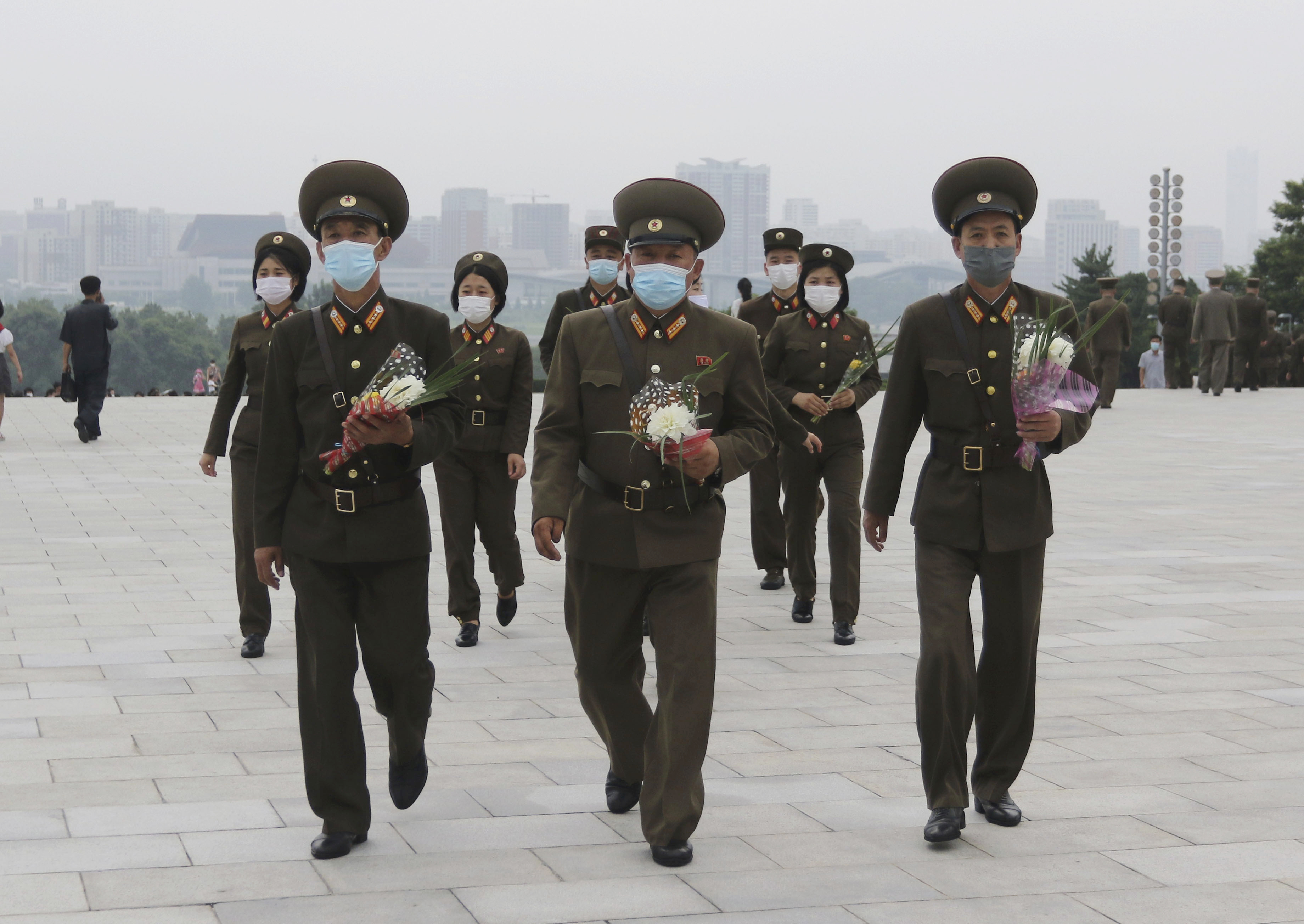 North Korean military personnel visit the statues of former North Korean leaders Kim Il Sung and Kim Jong Il