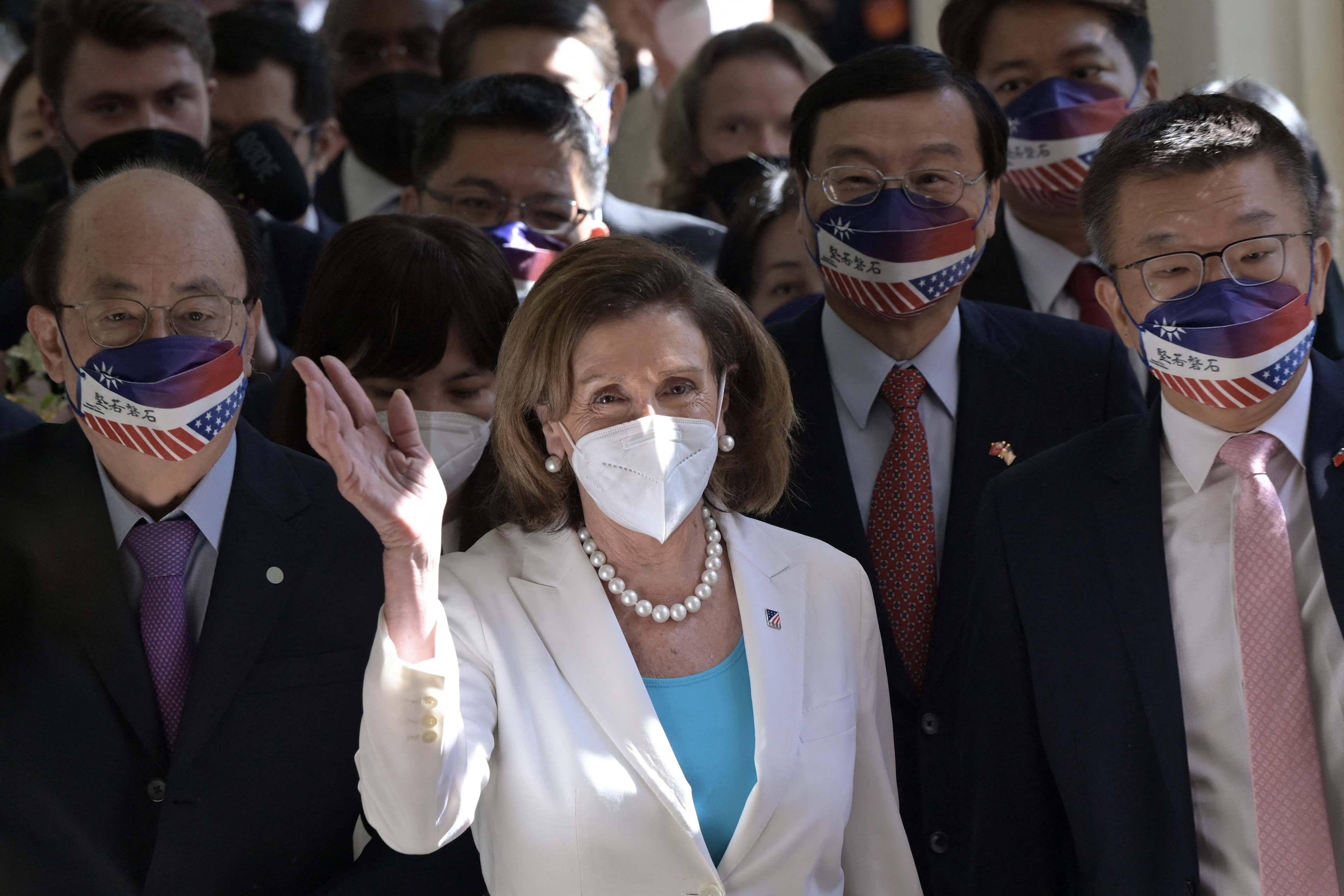 Visiting US House Speaker Nancy Pelosi waves to journalists during her arrival at the Parliament in Taipei, Taiwan.