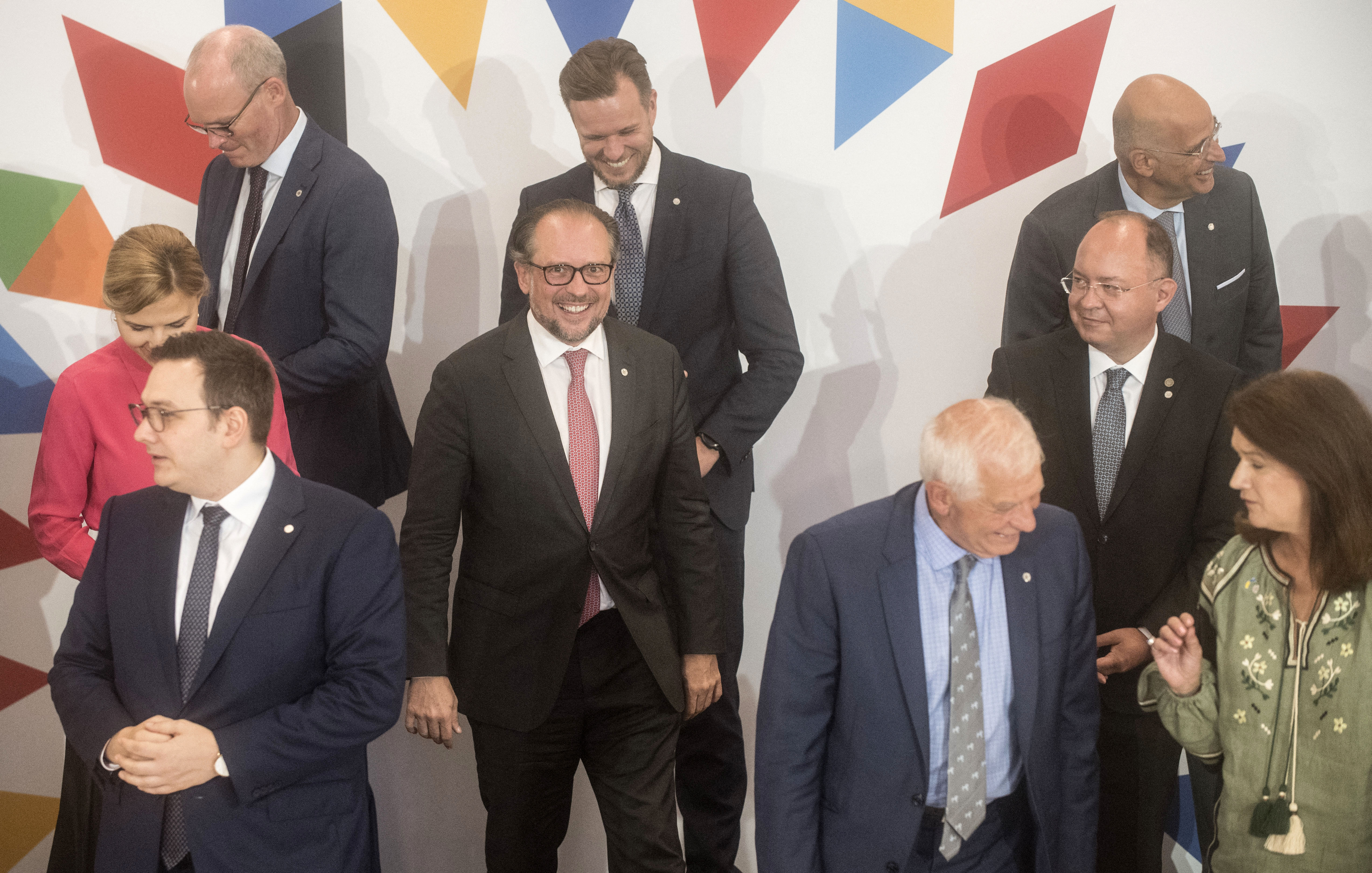 Austria's Foreign Minister Alexander Schallenberg (C) smiles after posing for a family photo with other participants of an informal meeting of EU Foreign Ministers (Gymnich) on August 31, 2022 in Prague, Czech Republic.