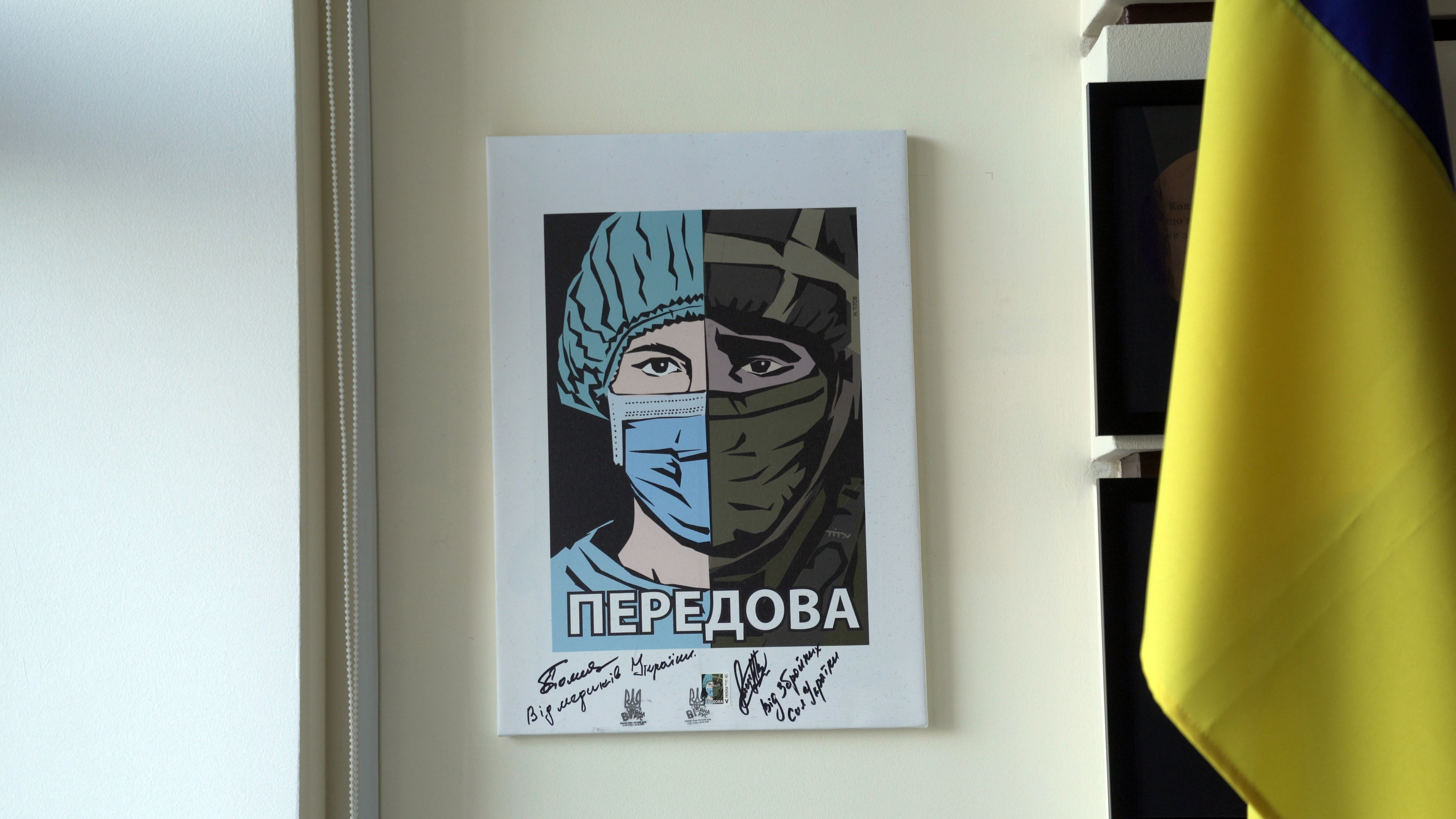 Wartime art inside Igor Smelyansky’s office [Shelby Wilder/Al Jazeera]