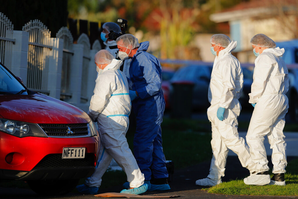 New Zealand police investigators in Auckland on August 11, 2022, after bodies were discovered in suitcases.