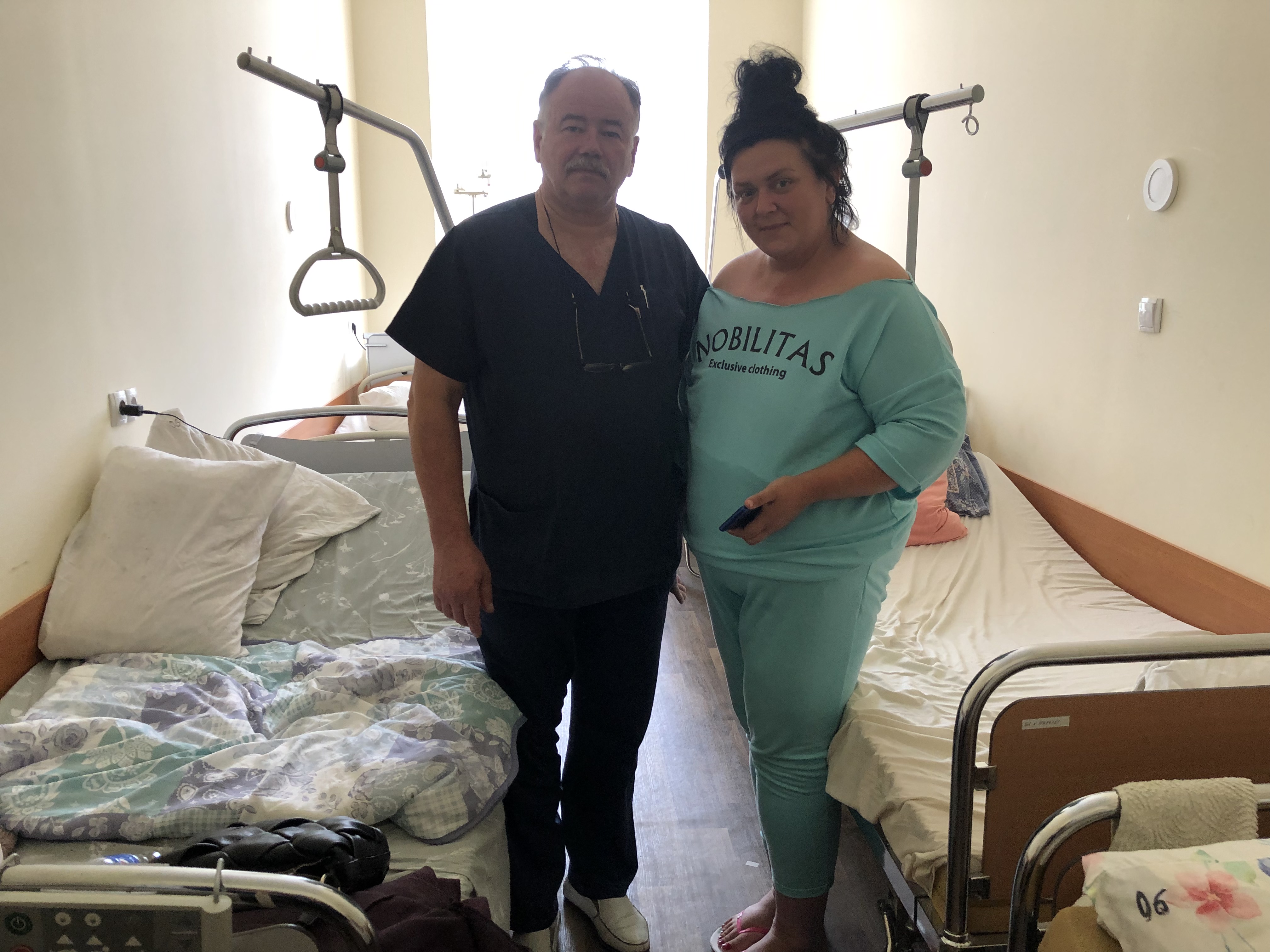 A photo of Yuriy Mikhel (left) standing next to Iryna Vetrova (right).