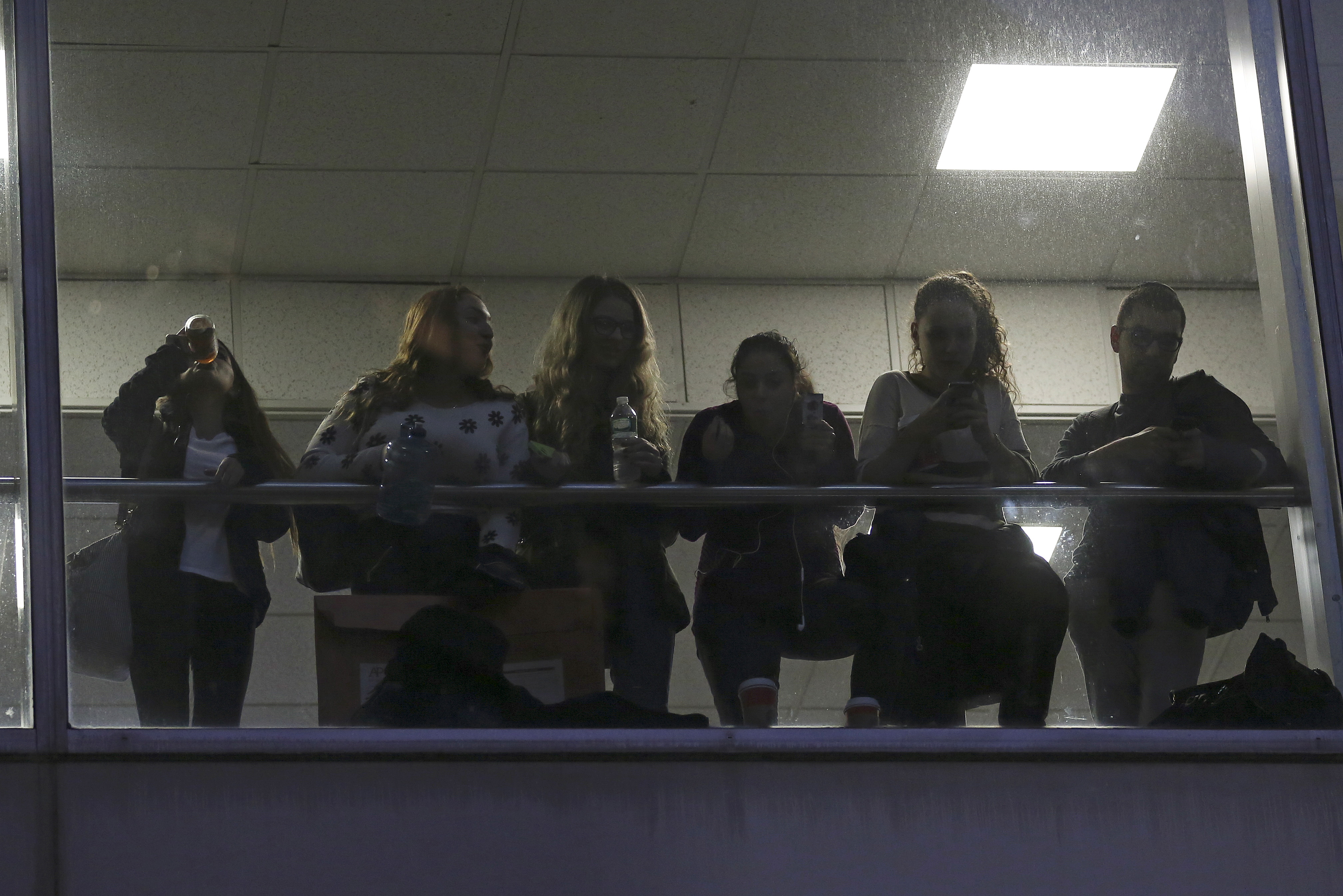 Students watch from a balcony during a demonstration calling for lower tuition at Hunter College in the Manhattan borough of New York