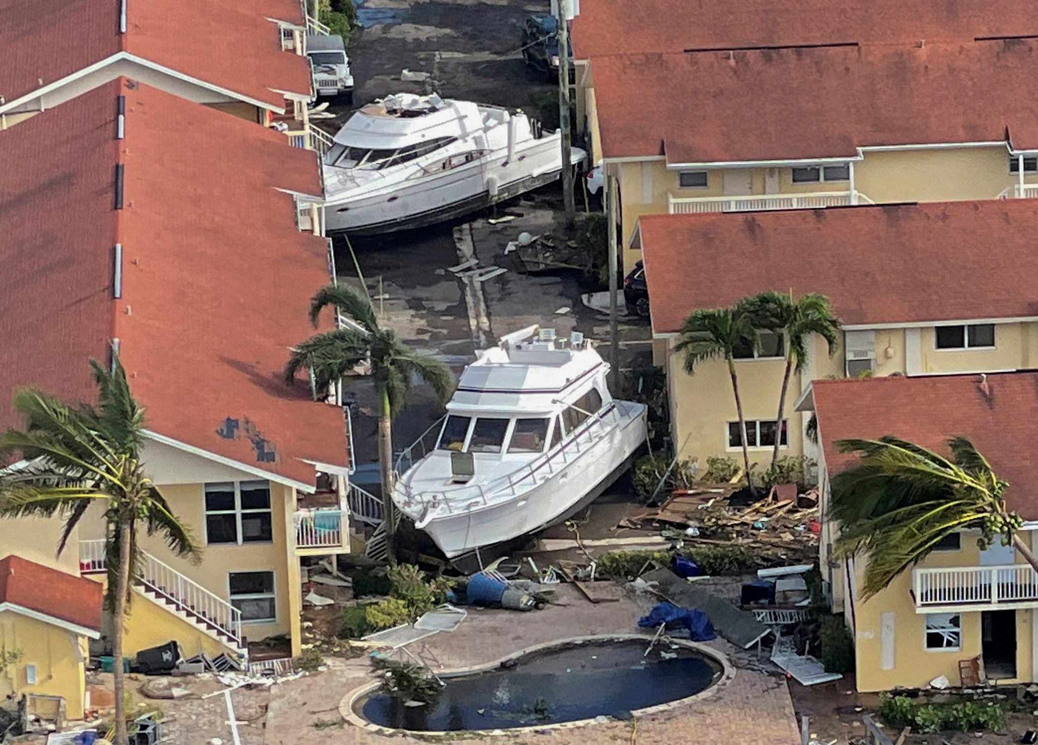 Damaged boats thrown between houses in Fort Myers by Hurricane Ian