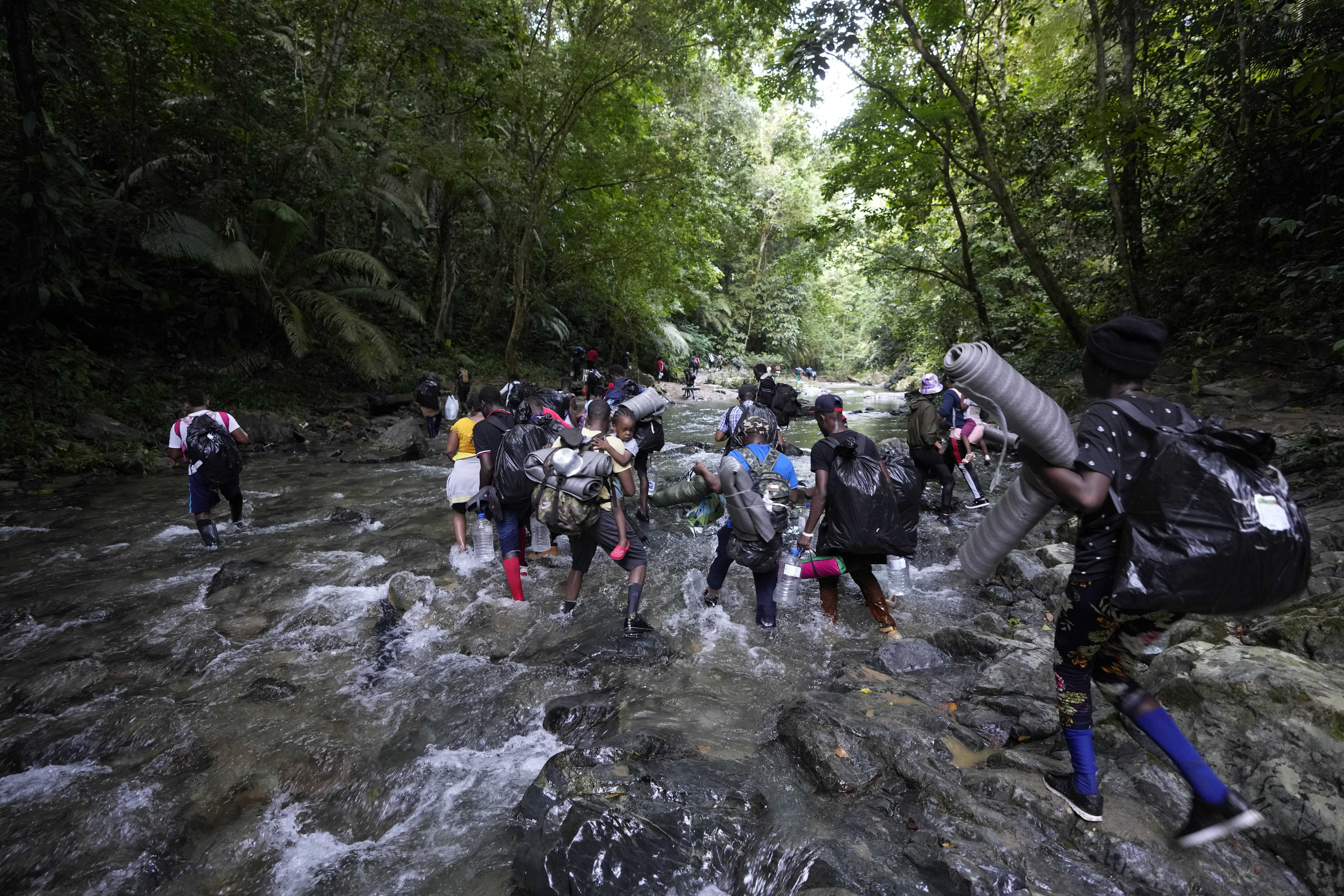 Refugees and migrants cross the Acandi River on their journey north, near Acandi, Colombia.