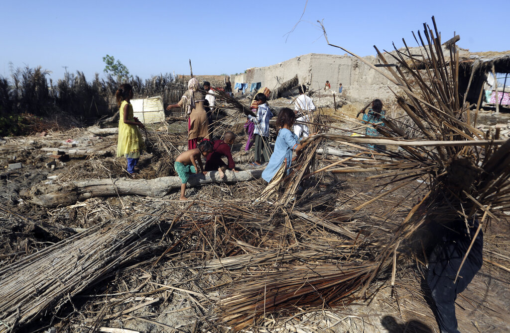 A family looks for belongings from their flooded home