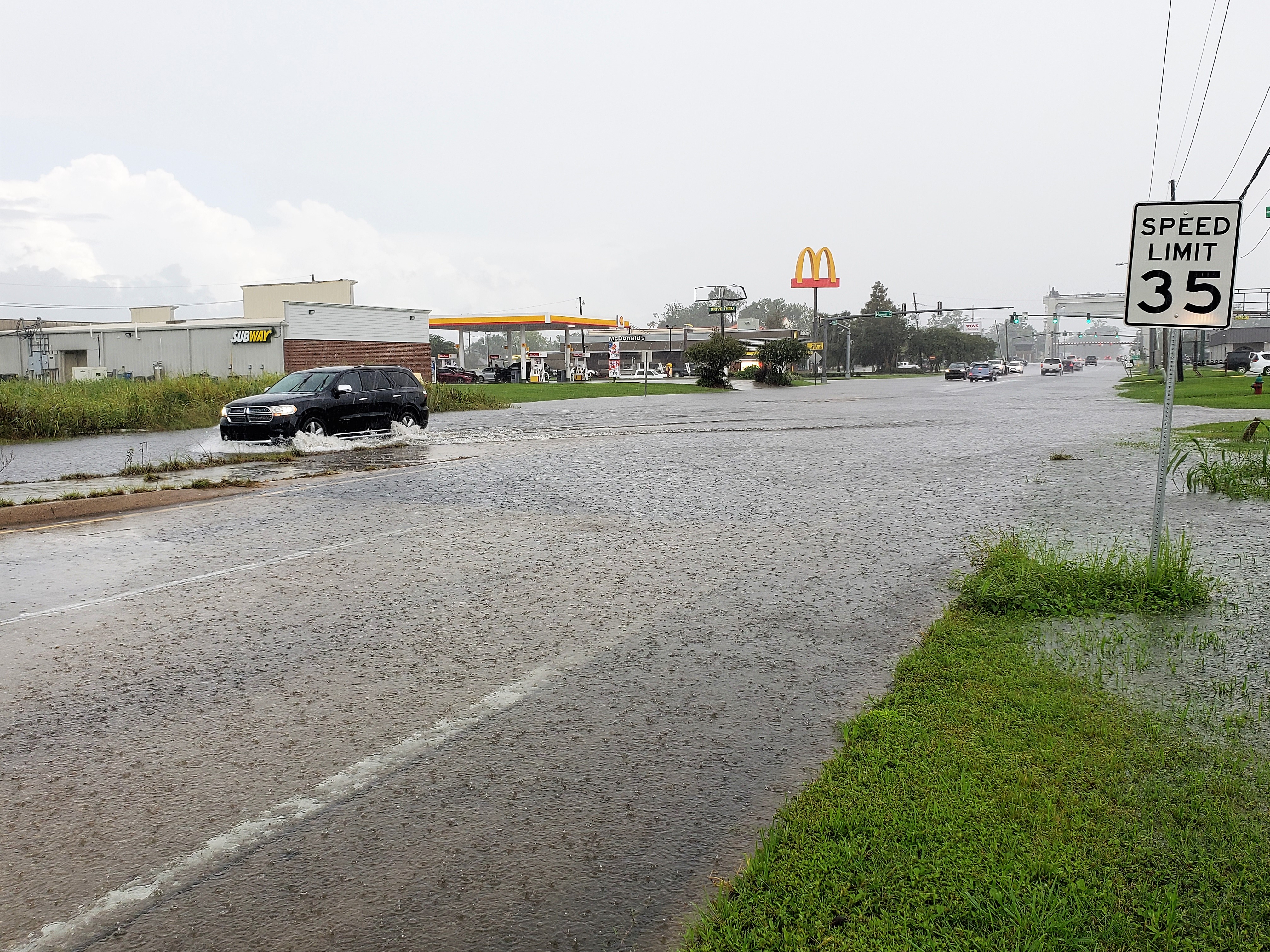 A photo of a street with a sign that says
