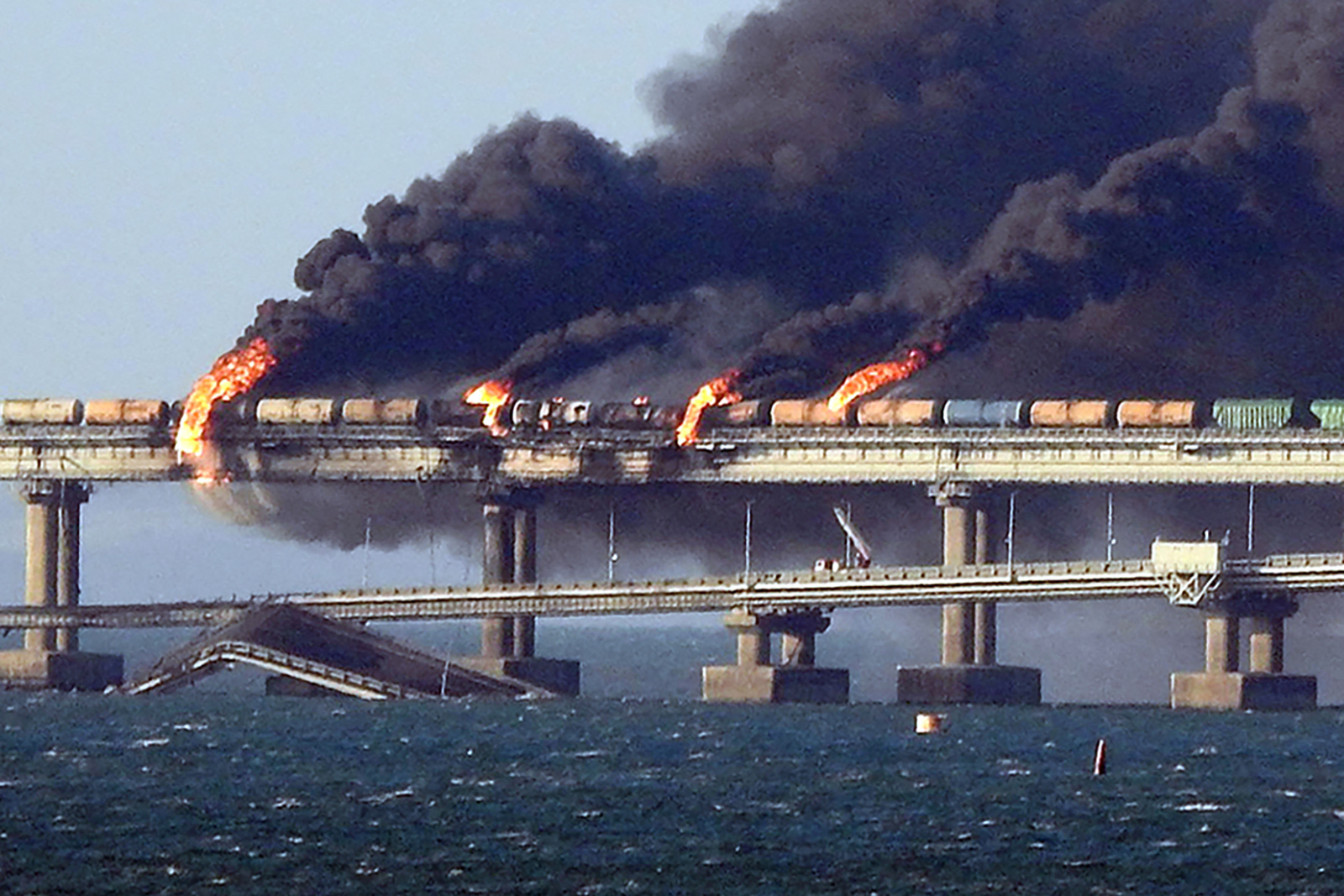 Black smoke billows from a fire on the Kerch bridge.
