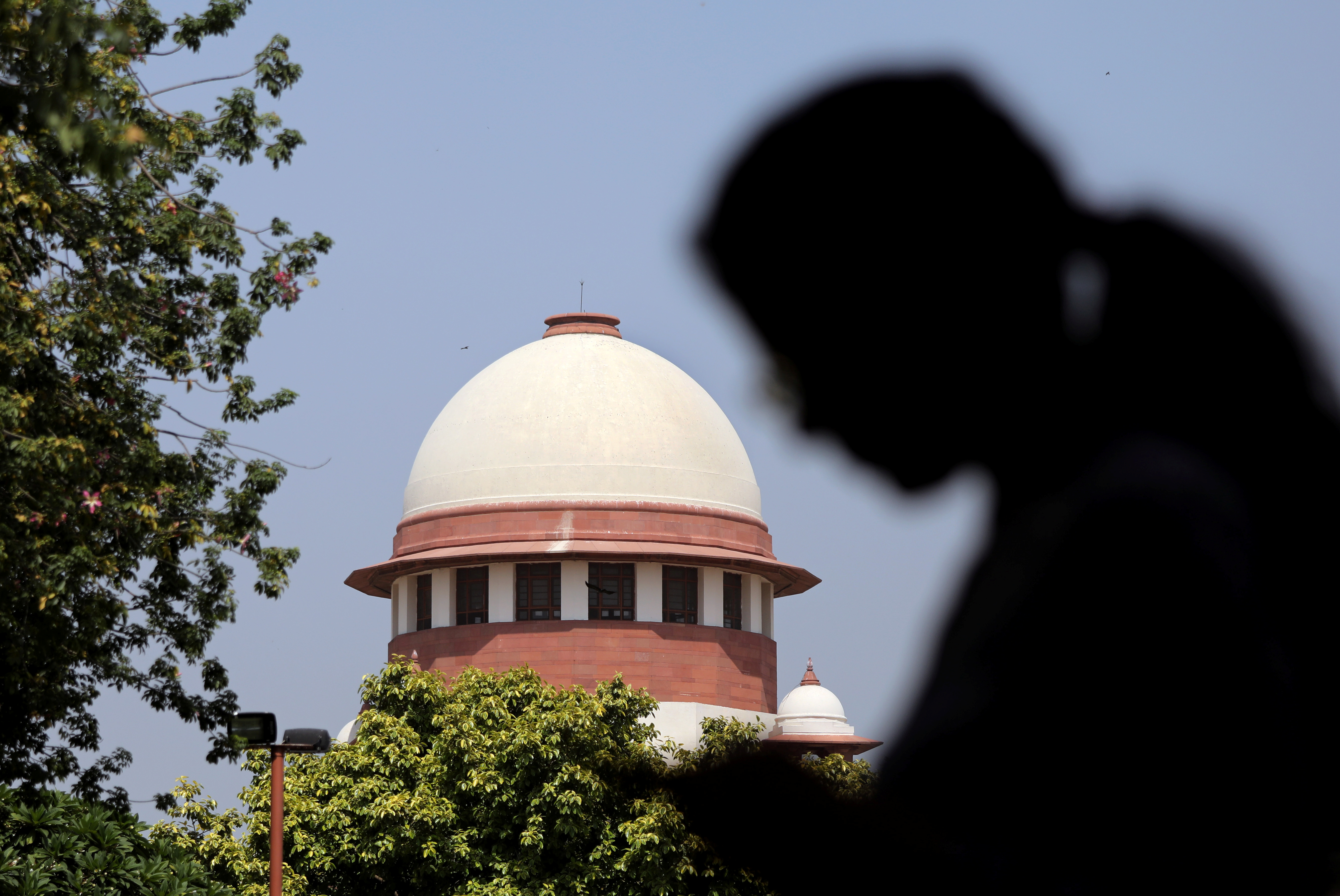 A woman checks her mobile phone inside the premises of the Supreme Court in New Delhi, India, September 28, 2018. REUTERS/Anushree Fadnavis