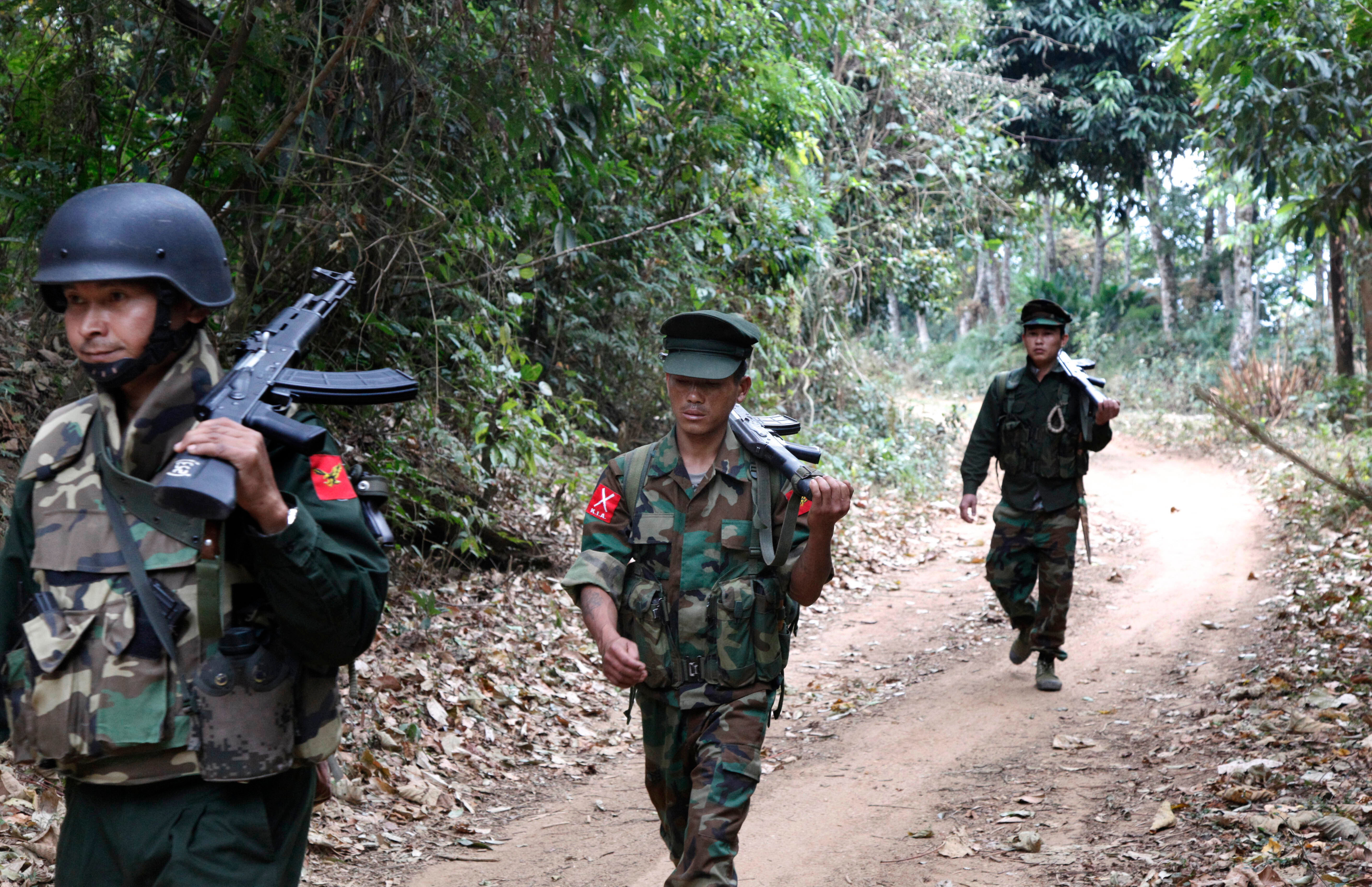 In this March 17, 2018 photo, Kachin Independence Army fighters walk in a jungle path in northern Kachin state, Myanmar.