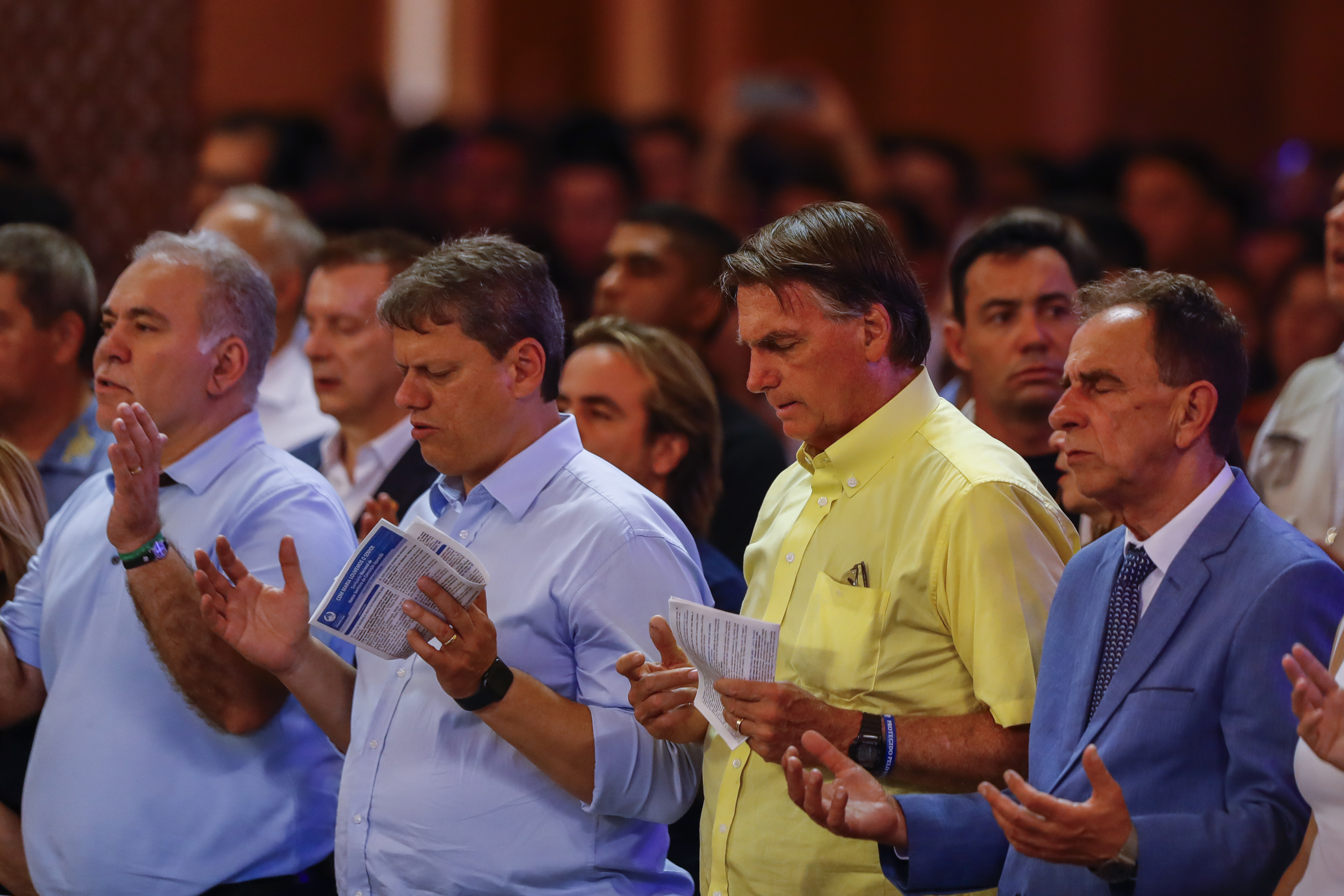 Brazil's President Jair Bolsonaro, second right, who running for reelection, and Sao Paulo candidate for governor Tarcisio de Freitas, center left, attend a Mass at the National Sanctuary of Our Lady Aparecida on her feast day in Aparecida, Sao Paulo state, Brazil, Wednesday, Oct. 12, 2022. Bolsonaro will face Luiz Inacio "Lula" da Silva in a presidential runoff on Oct. 30. (AP Photo/Marcelo Chello)