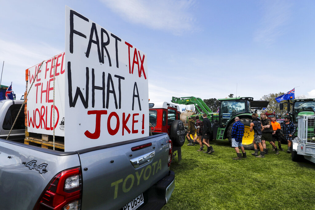 A sign on the back of a pickup truck reads 'FART TAX WHAT A JOKE!' as New Zealand farmers protest in central Auckland, New Zealand, on government plans to make them pay for greenhouse gas emissions.