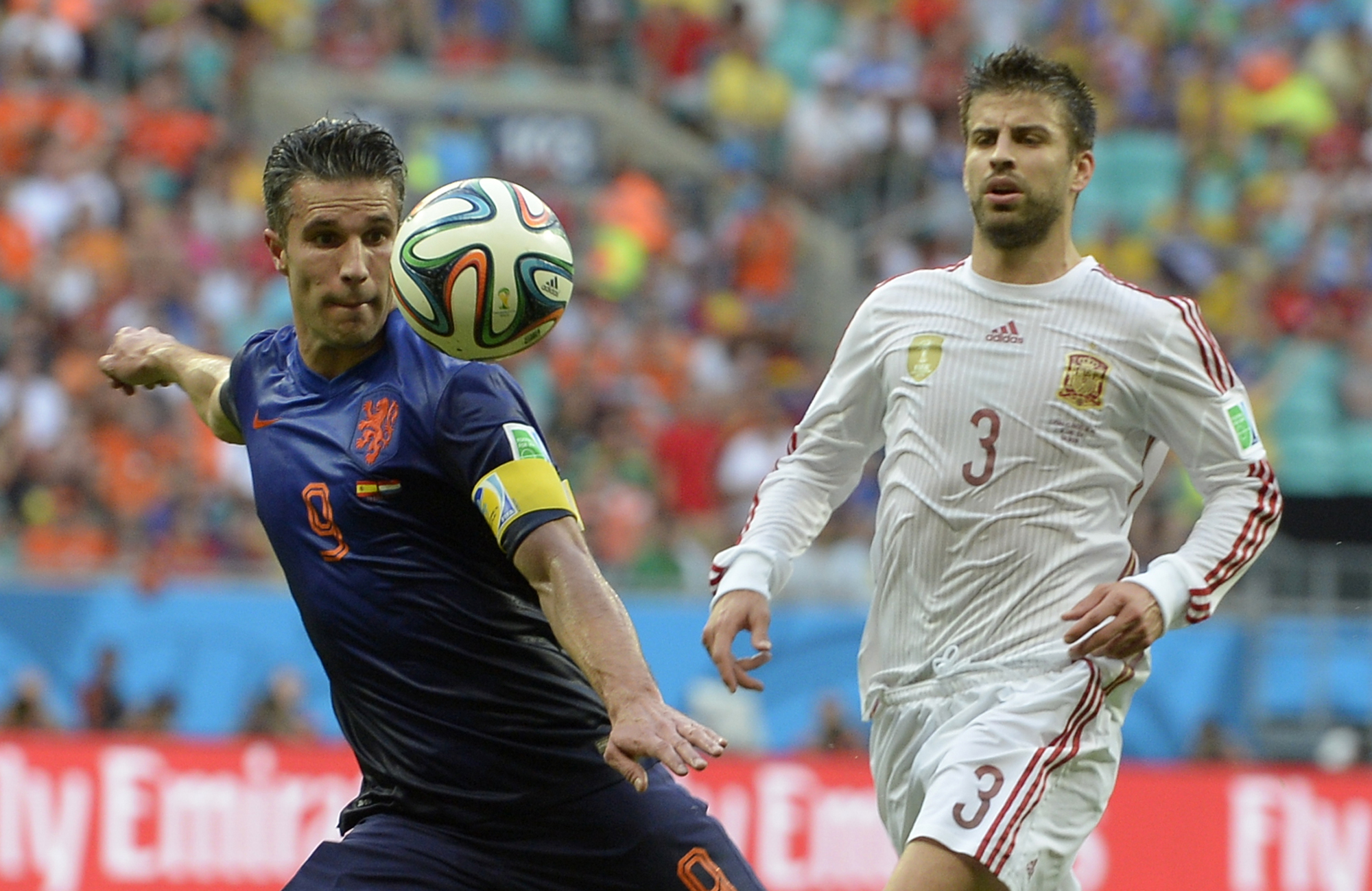 Netherlands' Robin van Persie, left, prepares to take a shot watched by Spain's Gerard Pique during the group B World Cup soccer match