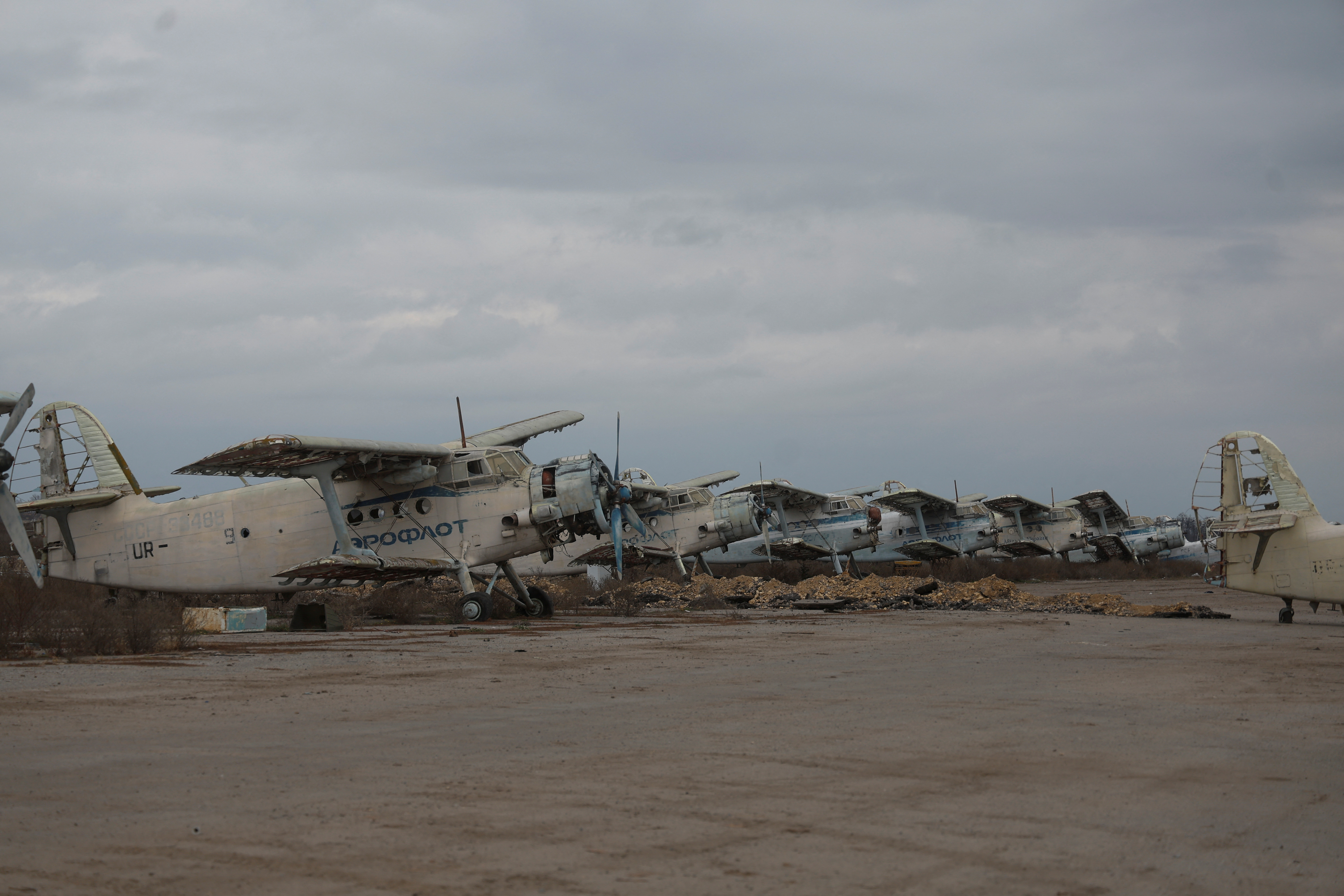 A view shows a destroyed old Antonov An-2 aircrafts at a compound of an international airport