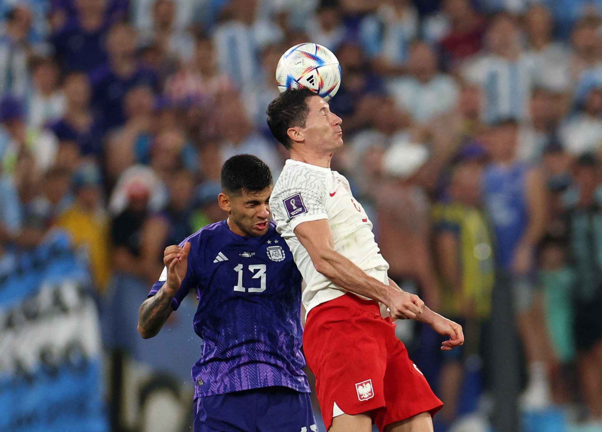 Poland's Robert Lewandowski in action with Argentina's Cristian Romero