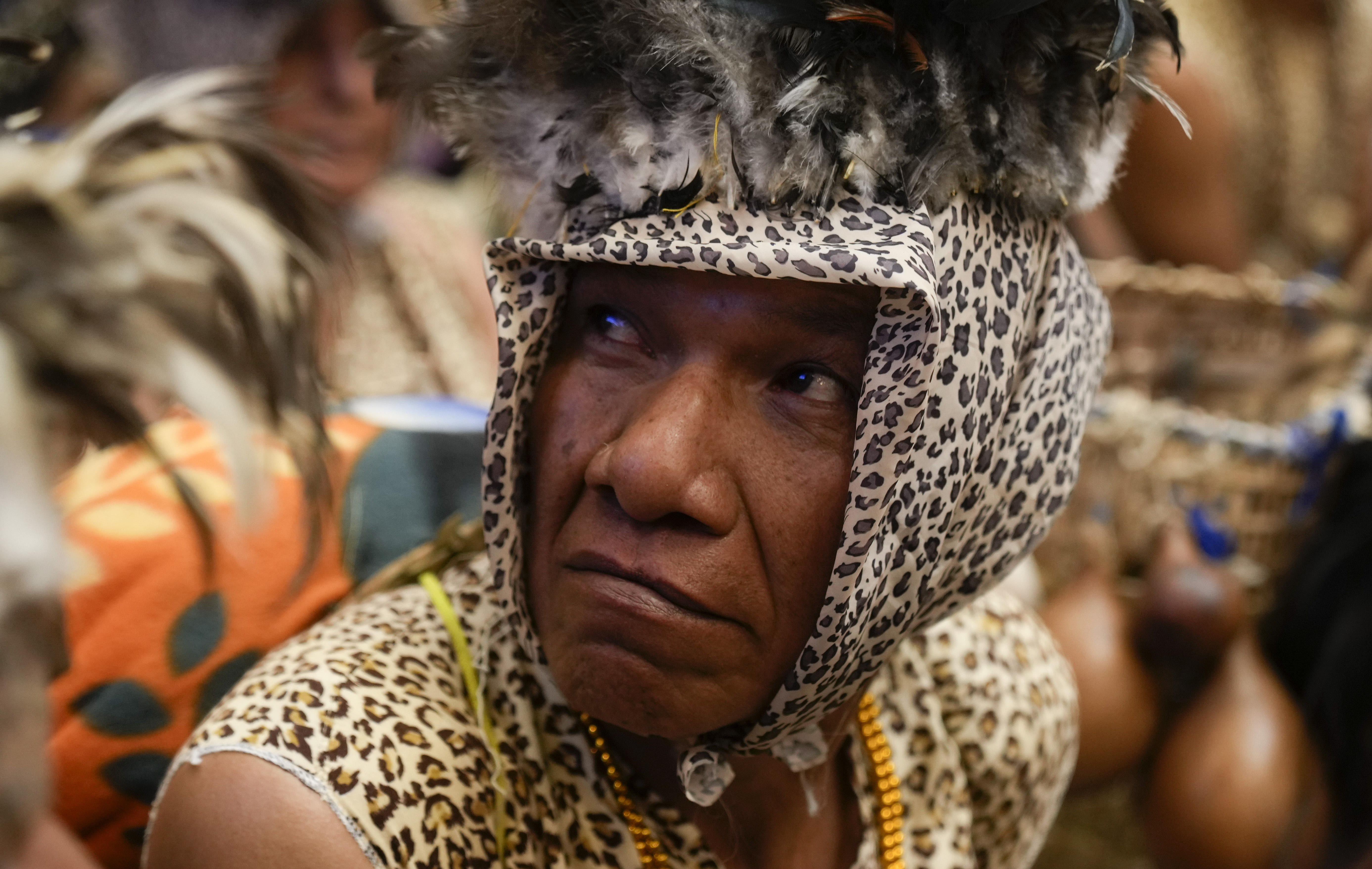 A member of the Leco Amazon Indigenous group joins a ceremony aimed at protecting his homeland in Madidi National Park from the gold mining industry