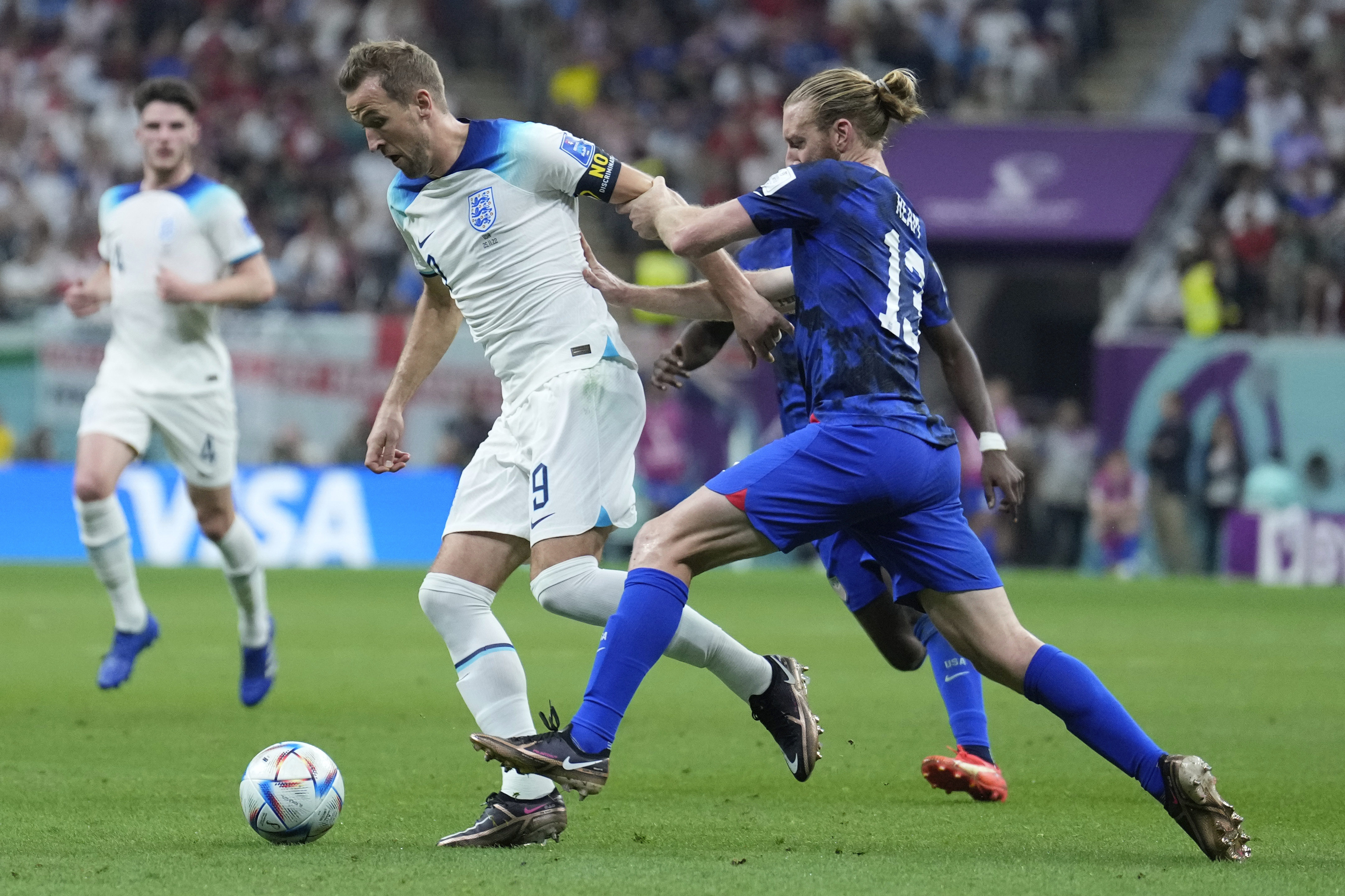 England’s Harry Kane, left, and Tim Ream of the United States fight for the ball during the World Cup group B match between England and The United States, at the Al Bayt Stadium in Al Khor , Qatar